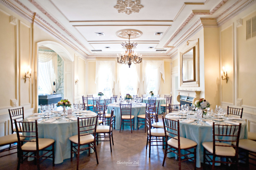 Christopher Luk - Toronto Wedding Portrait Event Photographer - Graydon Hall Manor - Blue Main Hall Room Wide Overview Chiavari Chairs Centrepieces Flatware Glassware Linens Tablecloths Flowers Floral Arrangements Mirror Chandelier Hardwood Floor Fireplace Mantel Crown Moulding