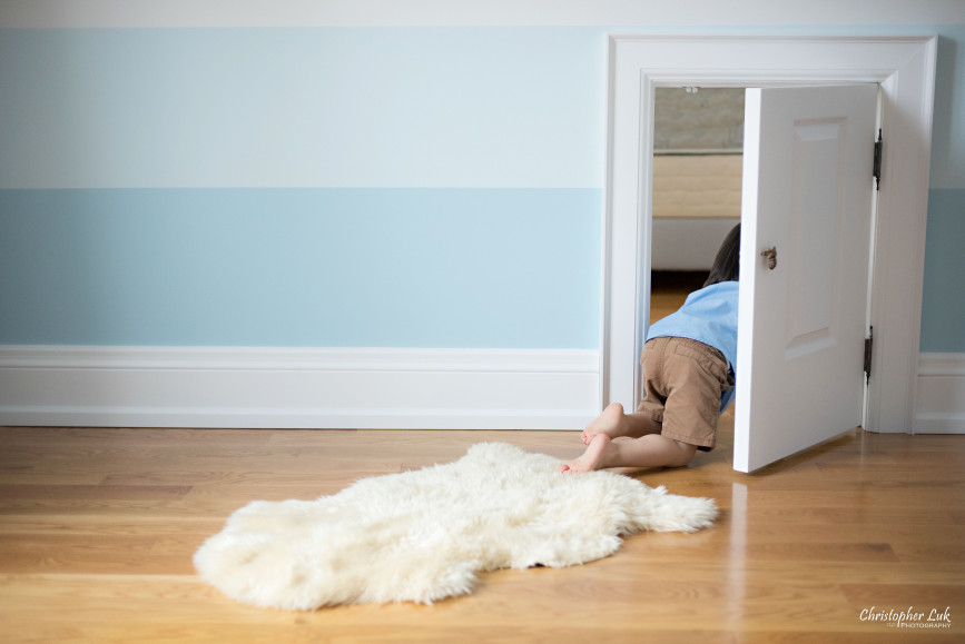 Christopher Luk 2015 - Toronto Family Toddler Winter Spring Indoor Home Session - Toddler Son Boy Blue Shirt Fashion Children Lifestyle Bedroom Fun Candid Photojournalistic Crawling Crawlspace Crawl Space Secret Door Passage Passageway Entrance Legs Crawling