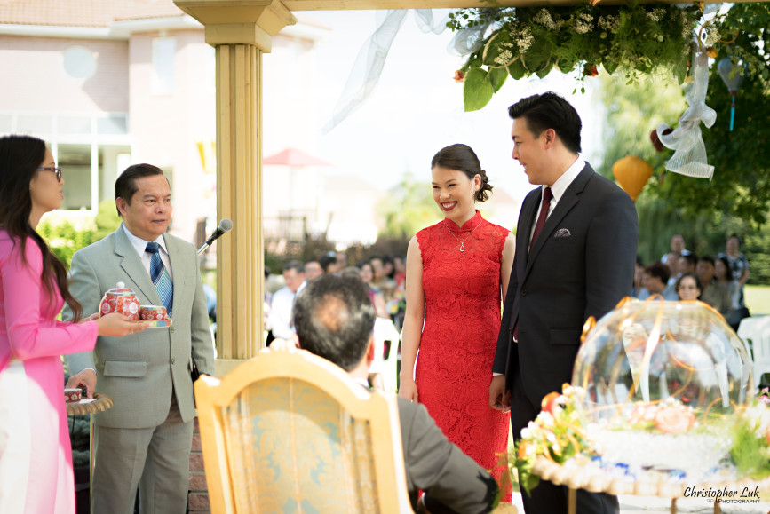 Christopher Luk 2015 - Vannessa and Daniel's Brampton Summer Outdoor Backyard Tea Ceremony Family Wedding Engagement Party Celebration - Bride Groom Navy Blue Suit Asian Red Dress Tea Ceremony Smile Laugh Candid Photojournalistic