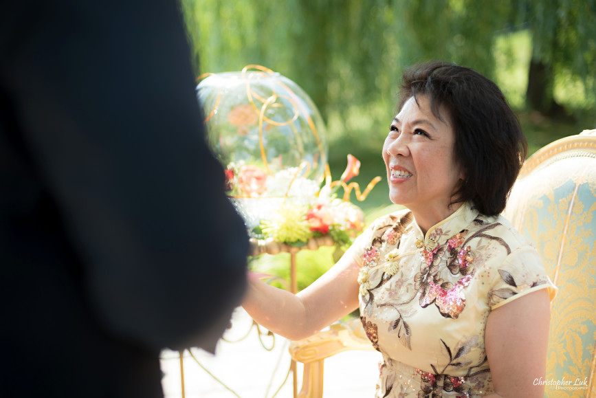 Christopher Luk 2015 - Vannessa and Daniel's Brampton Summer Outdoor Backyard Tea Ceremony Family Wedding Engagement Party Celebration - Bride Groom Navy Blue Suit Asian Red Dress Tea Ceremony Smile Laugh Candid Photojournalistic Mother Gold Dress