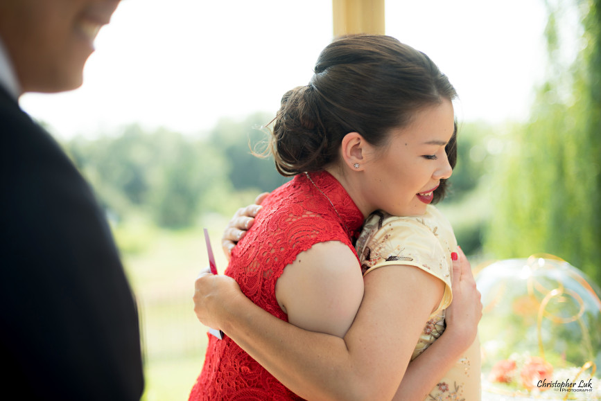 Christopher Luk 2015 - Vannessa and Daniel's Brampton Summer Outdoor Backyard Tea Ceremony Family Wedding Engagement Party Celebration - Bride Groom Navy Blue Suit Asian Red Dress Tea Ceremony Smile Laugh Candid Photojournalistic Mother Daughter Hug