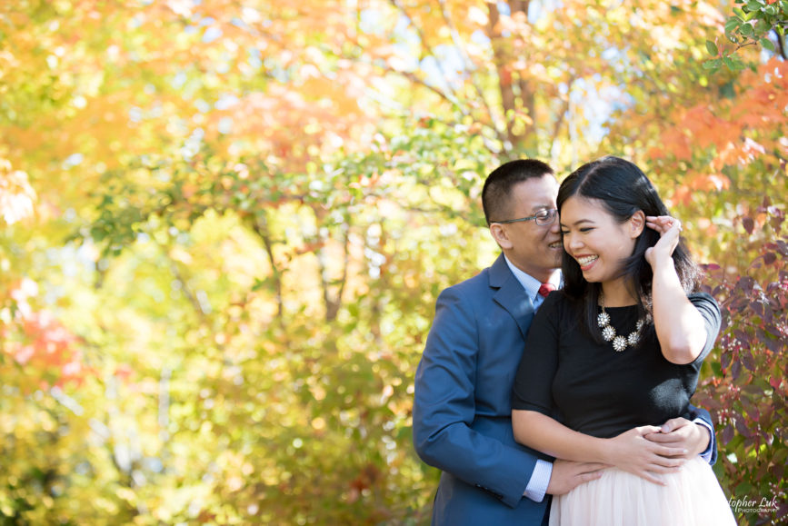 Christopher Luk - Toronto Vaughan Wedding Portrait Corporate Lifestyle Event Engagement Session PreWedding Photographer - The Doctor's House Main Street Kleinburg Conservation Woods Park Autumn Fall Leaves Bride Groom Pink Tulle Skirt Blue Suit Red Tie Golden Glowing Forest Trees Hug Crystal Necklace Smile