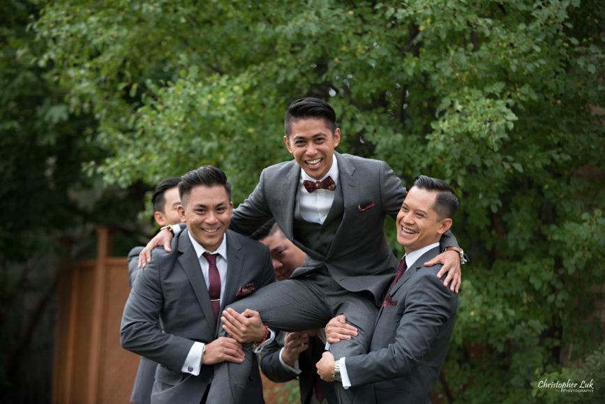 Christopher Luk Toronto Wedding Portrait Lifestyle Event Photographer - Eagles Nest Golf Club Outdoor Ceremony Toronto Raptors Blue Jays Sports Fans Candid Natural Photojournalistic Groom Groomsmen JCrew J Crew Grey Suits Funny Fun Laughing Carried