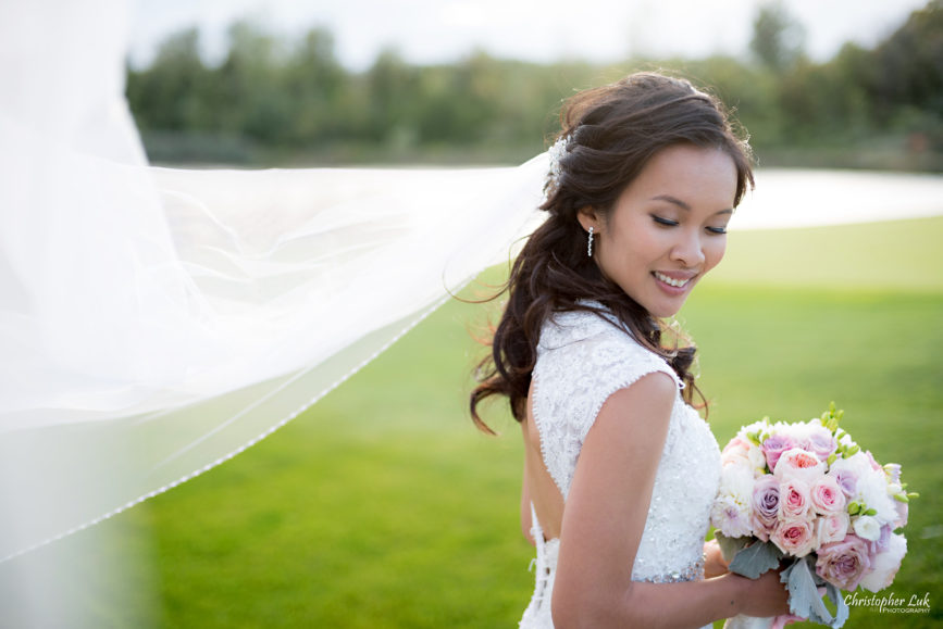 Christopher Luk Toronto Wedding Portrait Lifestyle Event Photographer - Eagles Nest Golf Club Outdoor Ceremony Toronto Raptors Blue Jays Sports Fans Candid Natural Photojournalistic Bride Bouquet Blowing in the Wind Veil Portrait