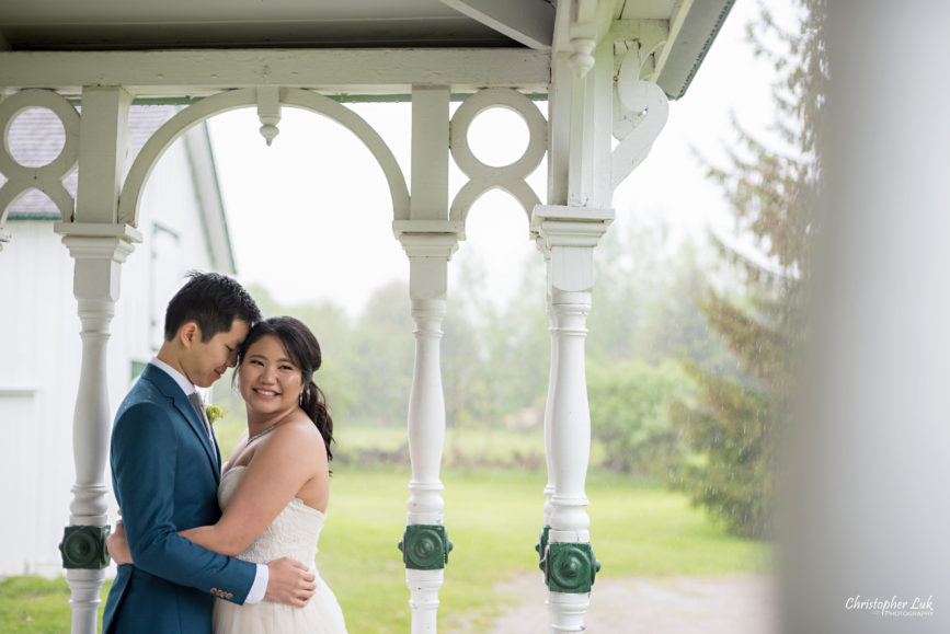 Christopher Luk: Toronto Wedding Photographer: Markham Museum Scarborough Chinese Baptist Church SCBC Columbus Event Centre Sala Caboto Natural Candid Photojournalistic Bride Groom Portrait Hug Holding Each Other Close Leading Lines Historic White Wood Home Burkholder House Covered Porch Verandah Close Up Over the Shoulder Smile
