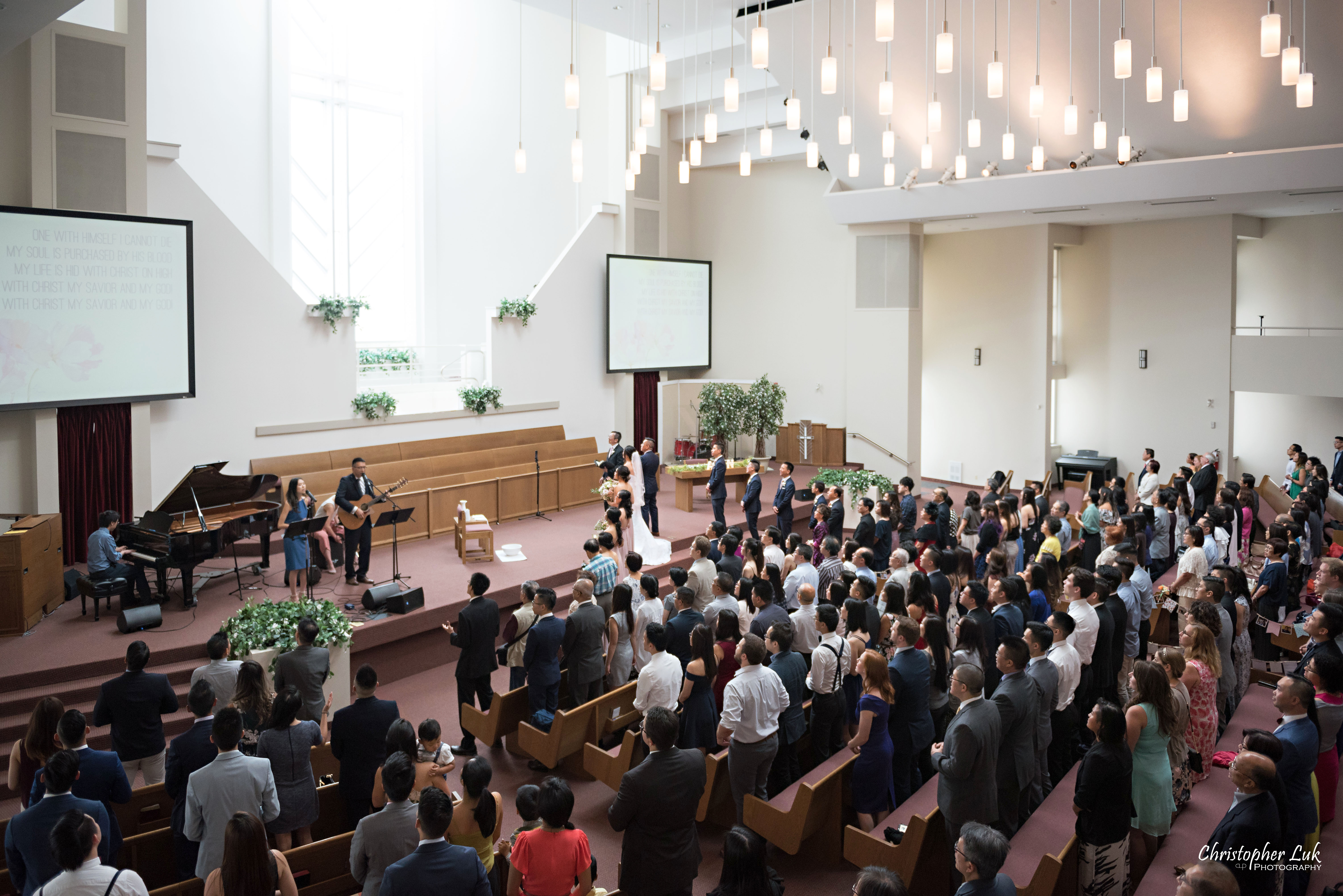 Christopher Luk - Toronto Wedding Photographer - Markham Chinese Baptist Church MCBC Christian Ceremony - Natural Candid Photojournalistic Bride Groom Friends Family Guests Congregation Wide Sanctuary Worship Left Corner