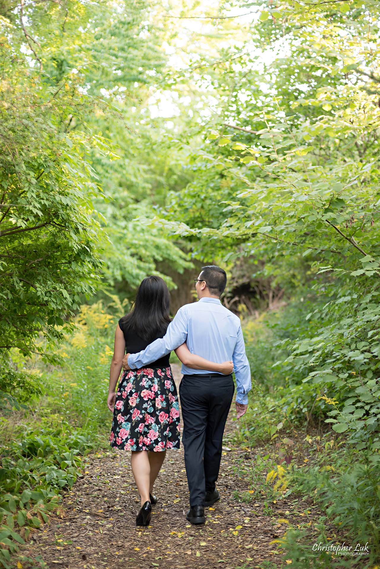Christopher Luk Toronto Wedding Family Event Corporate Commercial Headshot Photographer Edith Jeff Engagement Session Alexander Muir Memorial Gardens Park MidTown Photo Location Natural Candid Photojournalistic - Bride and Groom Walking Forest Pathway Hug Waist