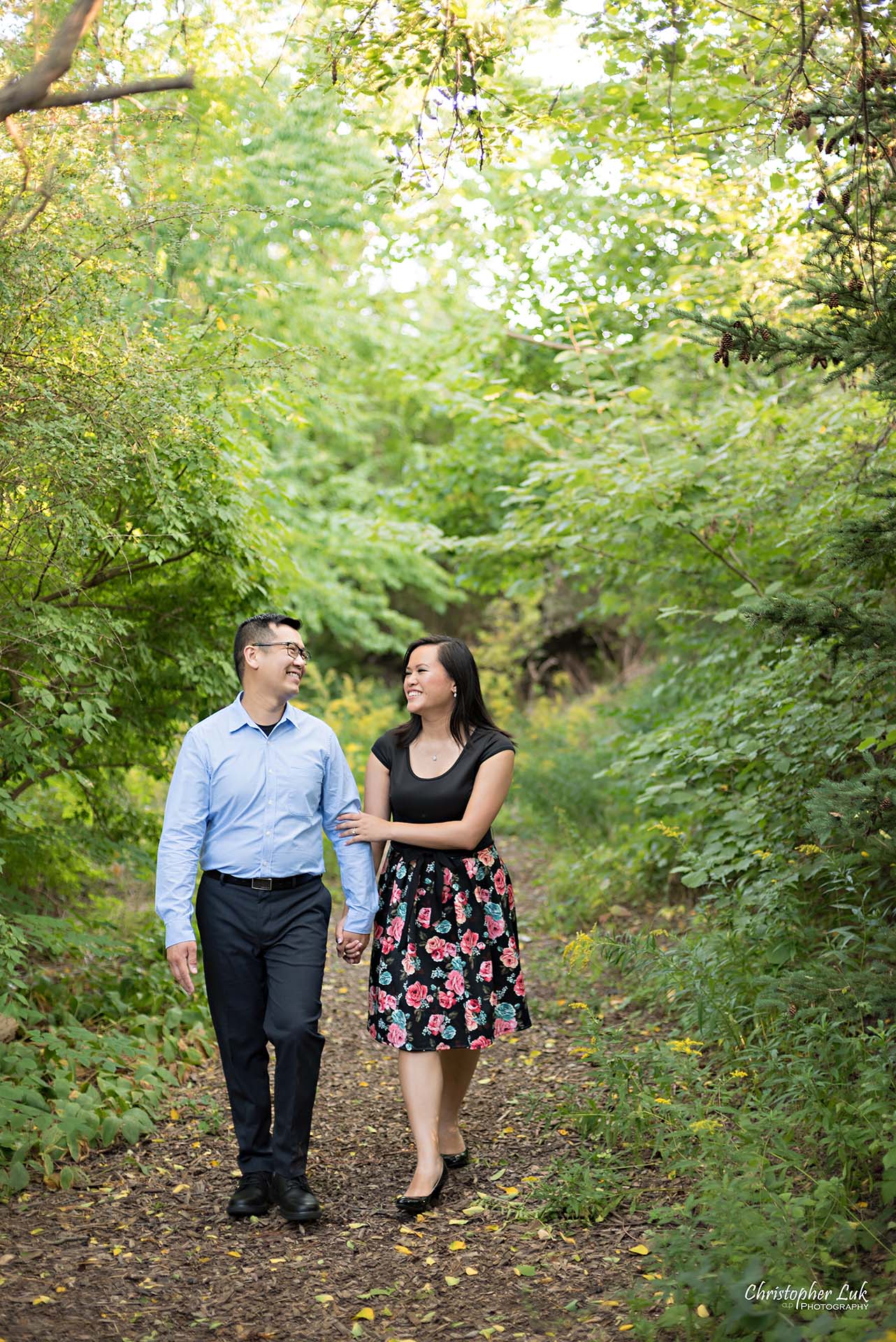 Christopher Luk Toronto Wedding Family Event Corporate Commercial Headshot Photographer Edith Jeff Engagement Session Alexander Muir Memorial Gardens Park MidTown Photo Location Natural Candid Photojournalistic - Bride and Groom Walking Forest Pathway Hug Arms