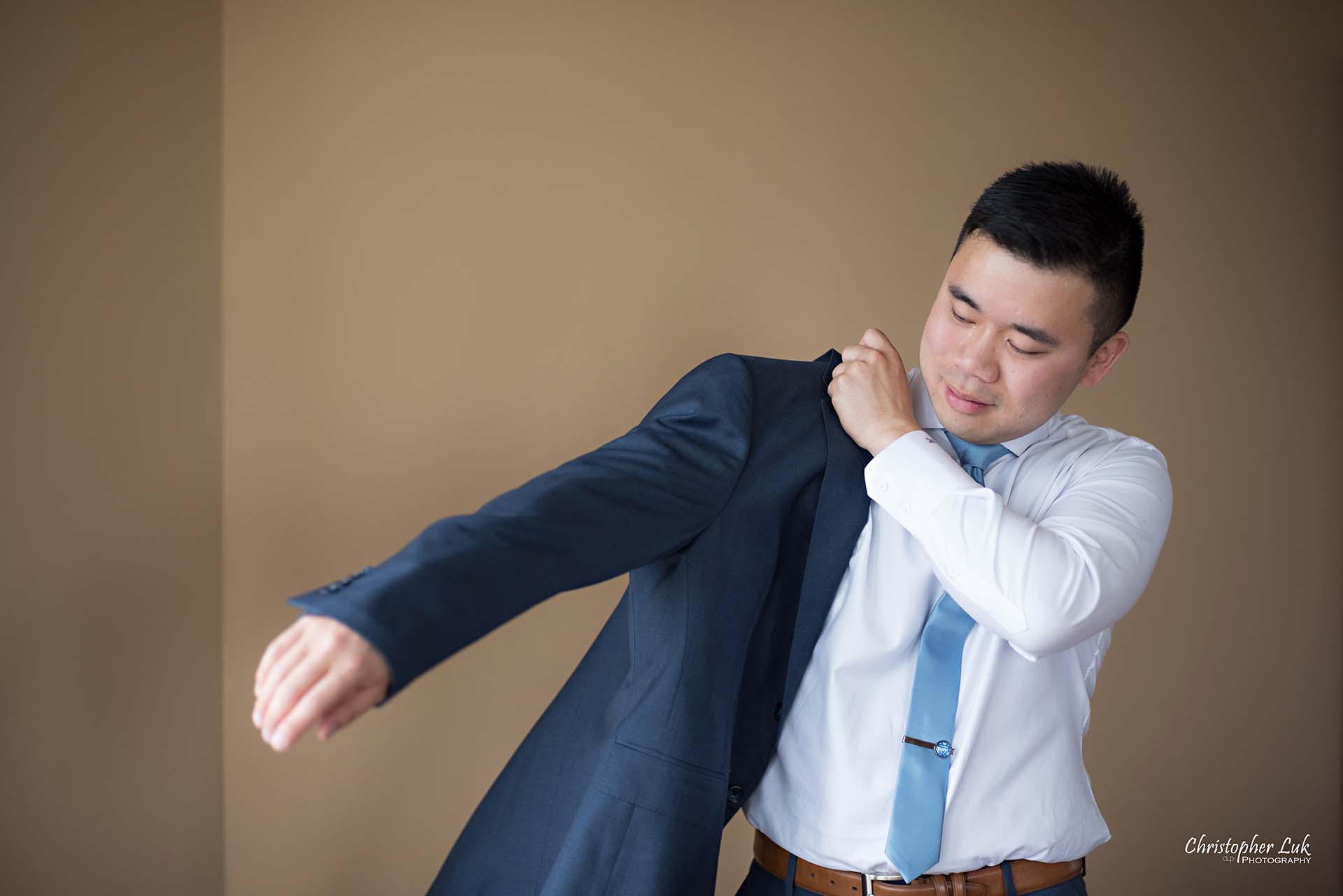 Christopher Luk Toronto Wedding Photographer Groom Getting Ready Preparations Natural Candid Photojournalistic Wingmen Suits Custom Made to Measure Navy Blue Suit Putting On