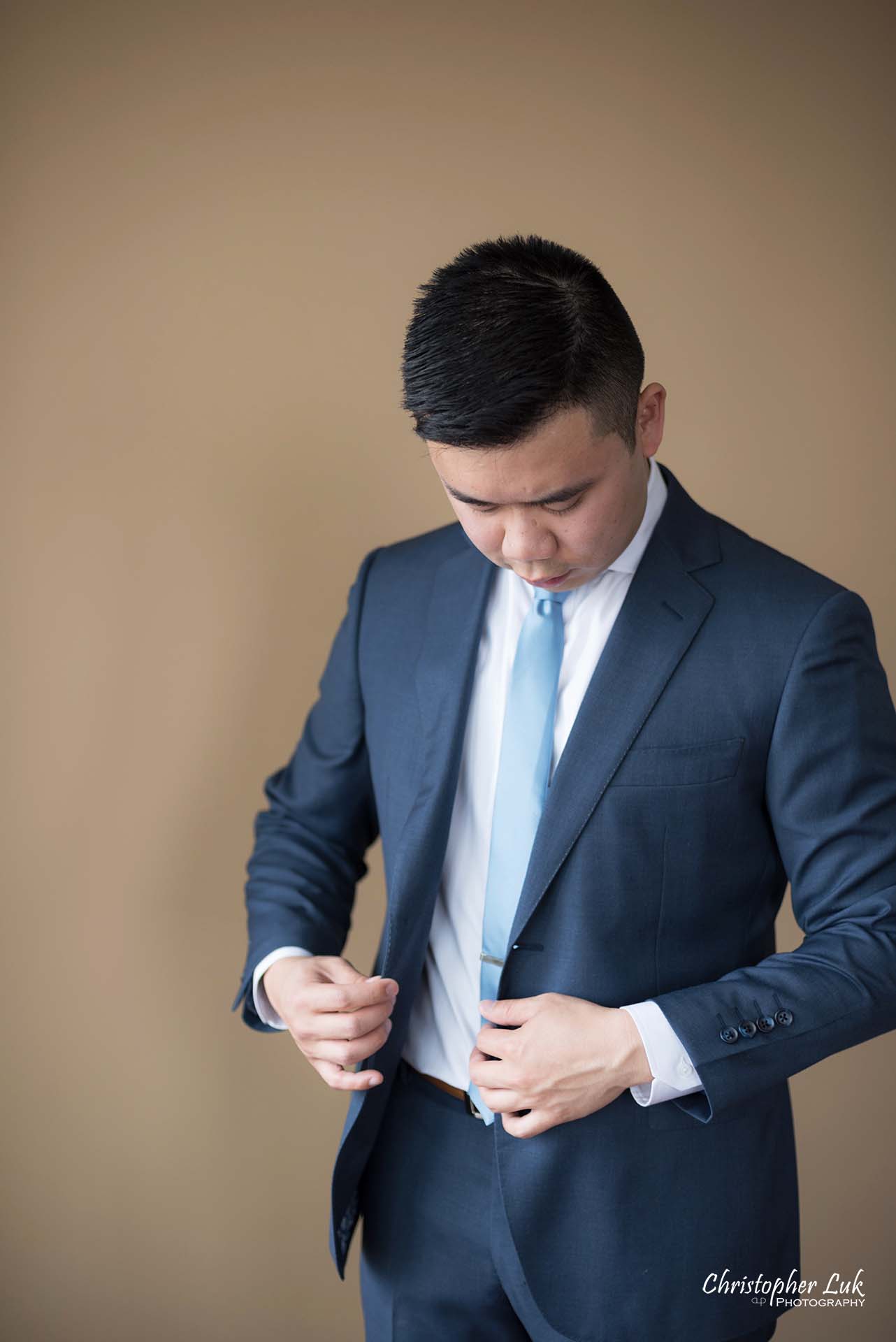 Christopher Luk Toronto Wedding Photographer Groom Getting Ready Preparations Natural Candid Photojournalistic Wingmen Suits Custom Made to Measure Navy Blue Suit Putting On Portrait