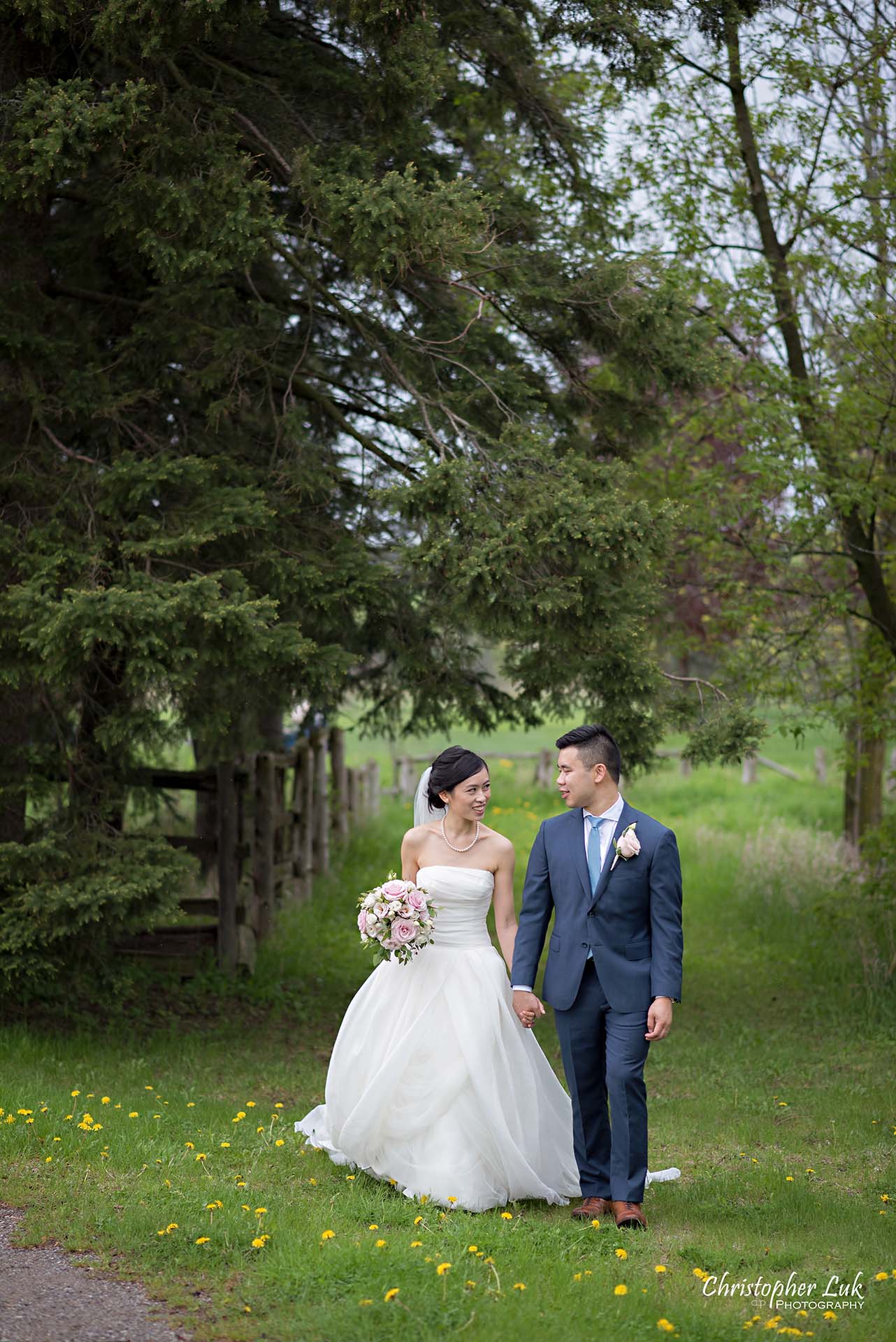 Christopher Luk Toronto Wedding Photographer Angus Glen Golf Club Markham Main Blue Barn Farm Historic Estate Building Together Natural Candid Photojournalistic Bride Groom Holding Hands Together Walking Green Trees