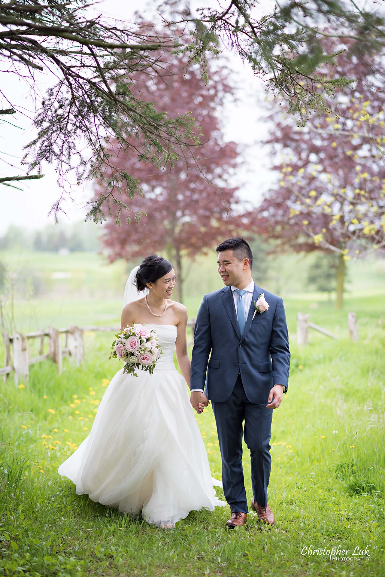 Christopher Luk Toronto Wedding Photographer Angus Glen Golf Club Markham Main Blue Barn Farm Historic Estate Building Together Natural Candid Photojournalistic Bride Groom Holding Hands Together Walking Green Grass Pathway Portrait