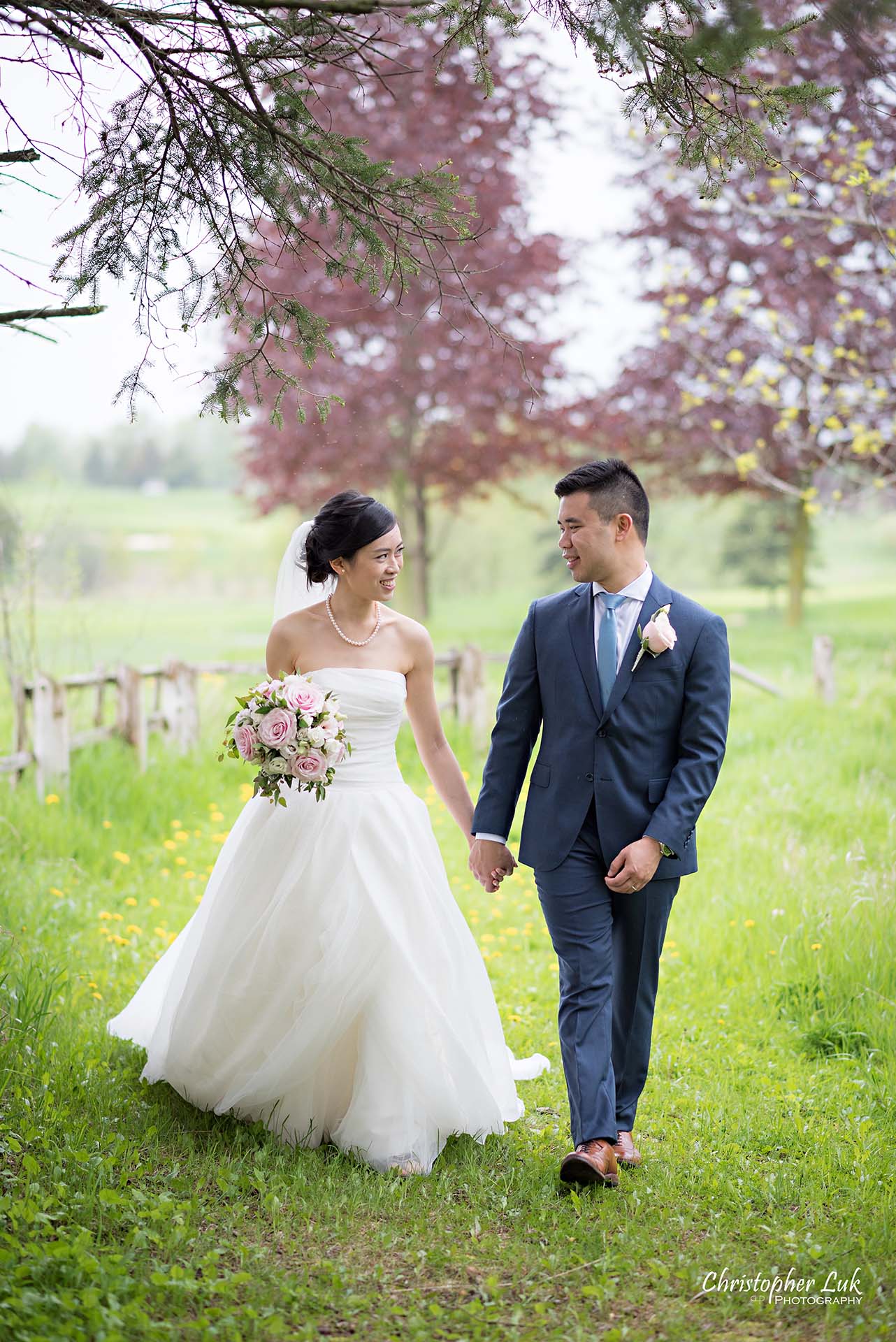 Christopher Luk Toronto Wedding Photographer Angus Glen Golf Club Markham Main Blue Barn Farm Historic Estate Building Together Natural Candid Photojournalistic Bride Groom Holding Hands Together Walking Green Grass Pathway Portrait 2