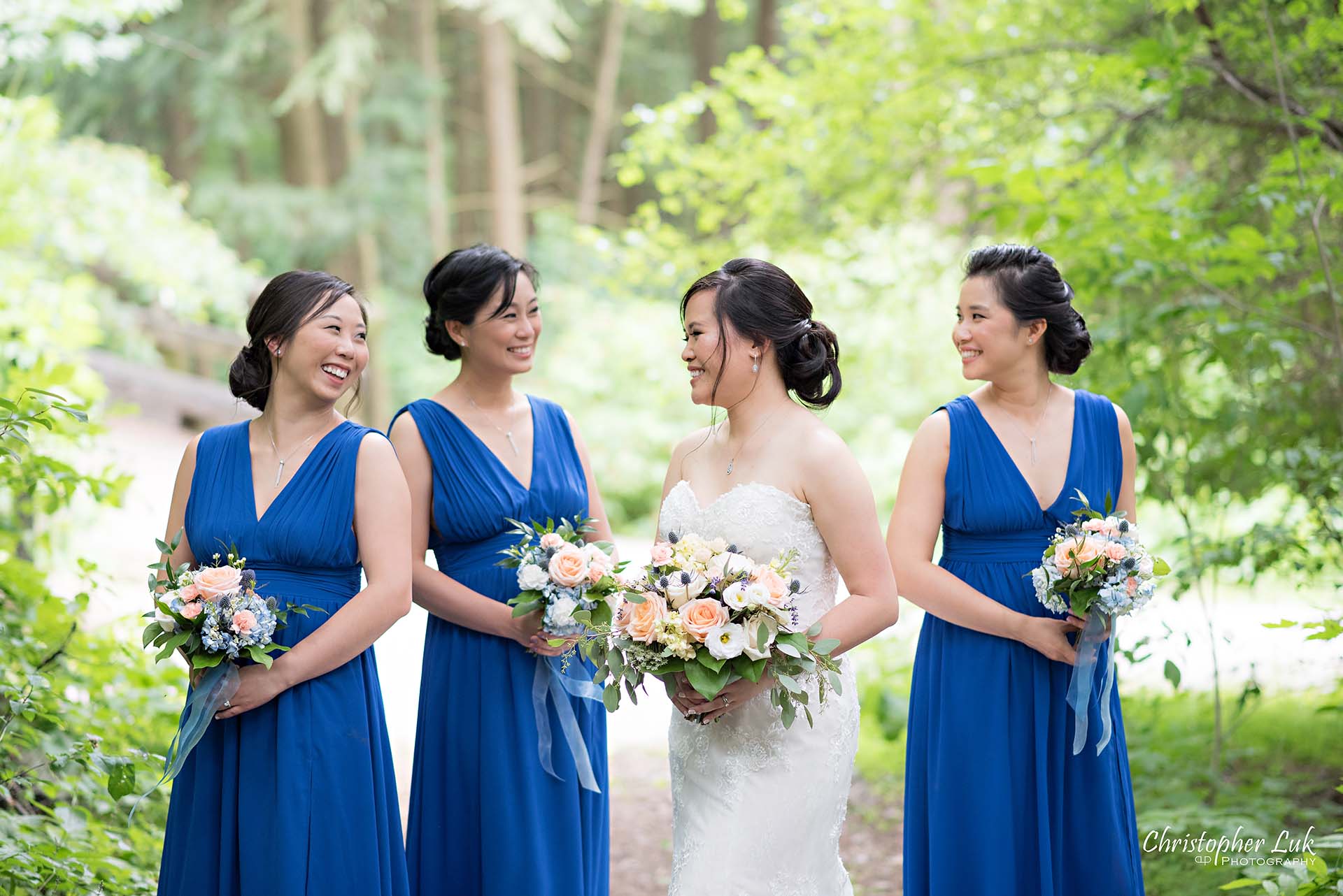 Christopher Luk Toronto Christian Community Church Kleinburg McMichael Art Gallery Presidente Banquet Hall Vaughan Wedding Photographer Bride Bridal Party Bridesmaids Matron Maid of Honour Natural Candid Photojournalistic Forest Woods Wooded Area Tall Trees Blue Dresses Laughing Together