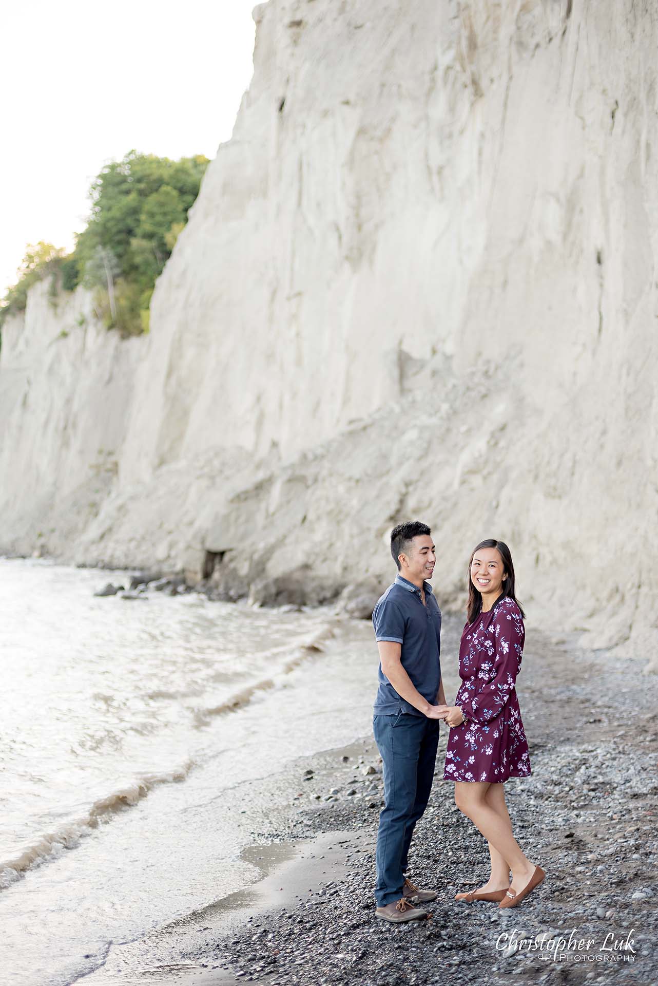 Christopher Luk Toronto Photographer Scarborough Bluffs Beach Park Sunset Surprise Wedding Marriage Engagement Proposal Candid Natural Photojournalistic Bride Groom Waterfront Water Lake Ontario Background Beachfront Sand Walking Together Holding Hands Edge of Water Smile Stone Portrait Laugh