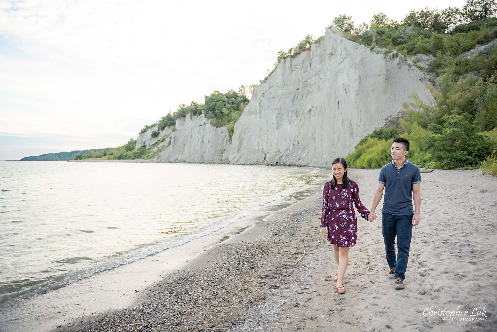 Christopher Luk Toronto Photographer Scarborough Bluffs Beach Park Sunset Surprise Wedding Marriage Engagement Proposal Candid Natural Photojournalistic Bride Groom Waterfront Water Lake Ontario Background Beachfront Sand Walking Together Holding Hands Edge of Water Smile Landscape Wide