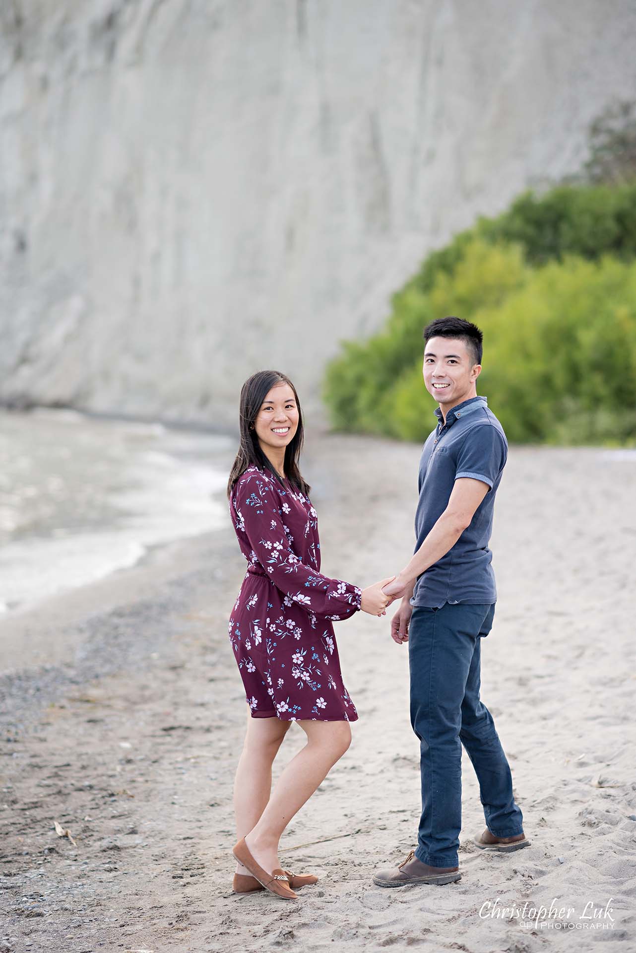 Christopher Luk Toronto Photographer Scarborough Bluffs Beach Park Sunset Surprise Wedding Marriage Engagement Proposal Candid Natural Photojournalistic Bride Groom Waterfront Water Lake Ontario Background Beachfront Sand Walking Together Holding Hands Edge of Water Smile Back at Camera Portrait
