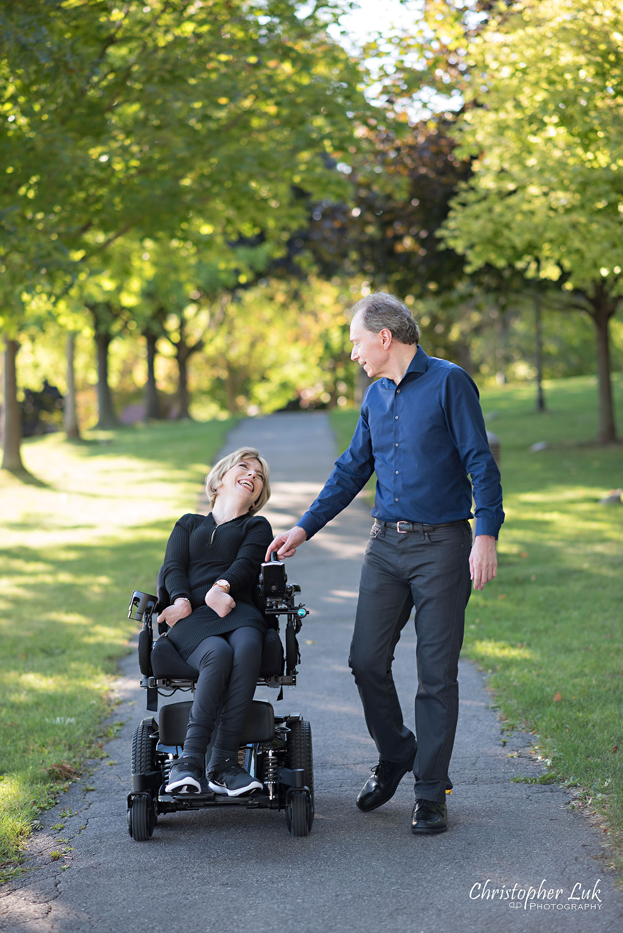Christopher Luk Toronto Wedding Photographer Whitby Durham Engagement Session Bride Groom Candid Natural Photojournalistic Wheelchair Path Pathway Walking Together Smile Laugh Looking at Each Other
