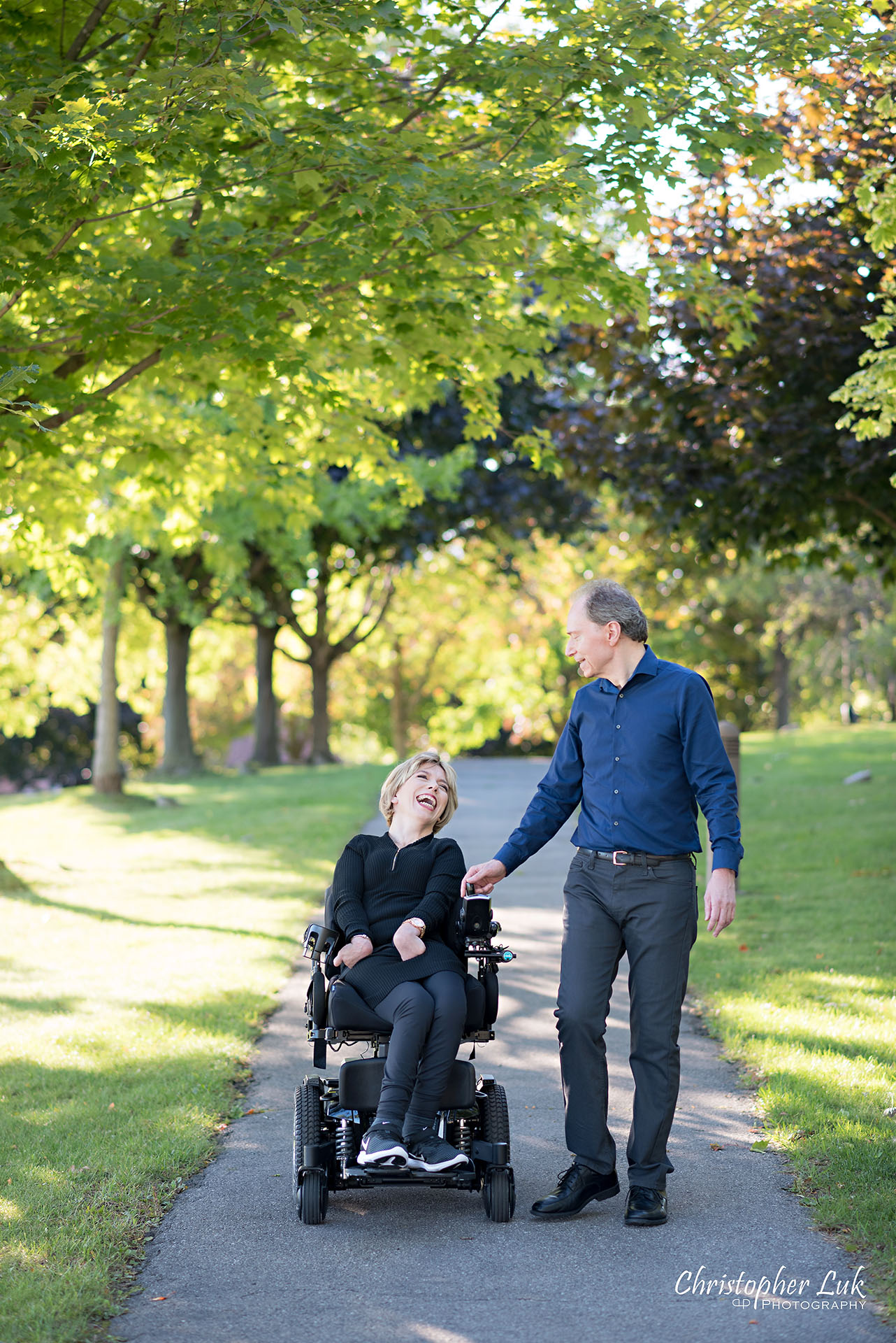 Christopher Luk Toronto Wedding Photographer Whitby Durham Engagement Session Bride Groom Candid Natural Photojournalistic Wheelchair Path Pathway Walking Together Smile Laugh Looking at Each Other