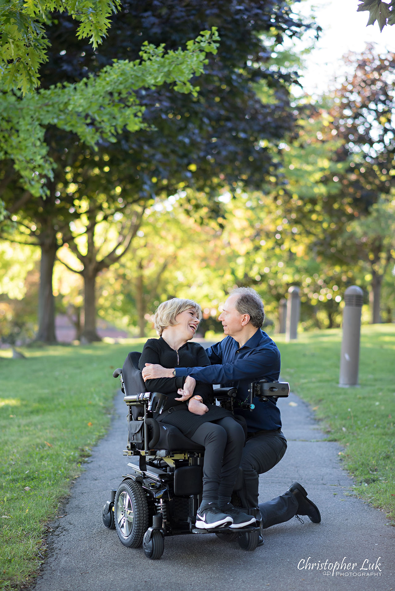 Christopher Luk Toronto Wedding Photographer Whitby Durham Engagement Session Bride Groom Candid Natural Photojournalistic Wheelchair Path Pathway Kneel Wrap Arms Hug