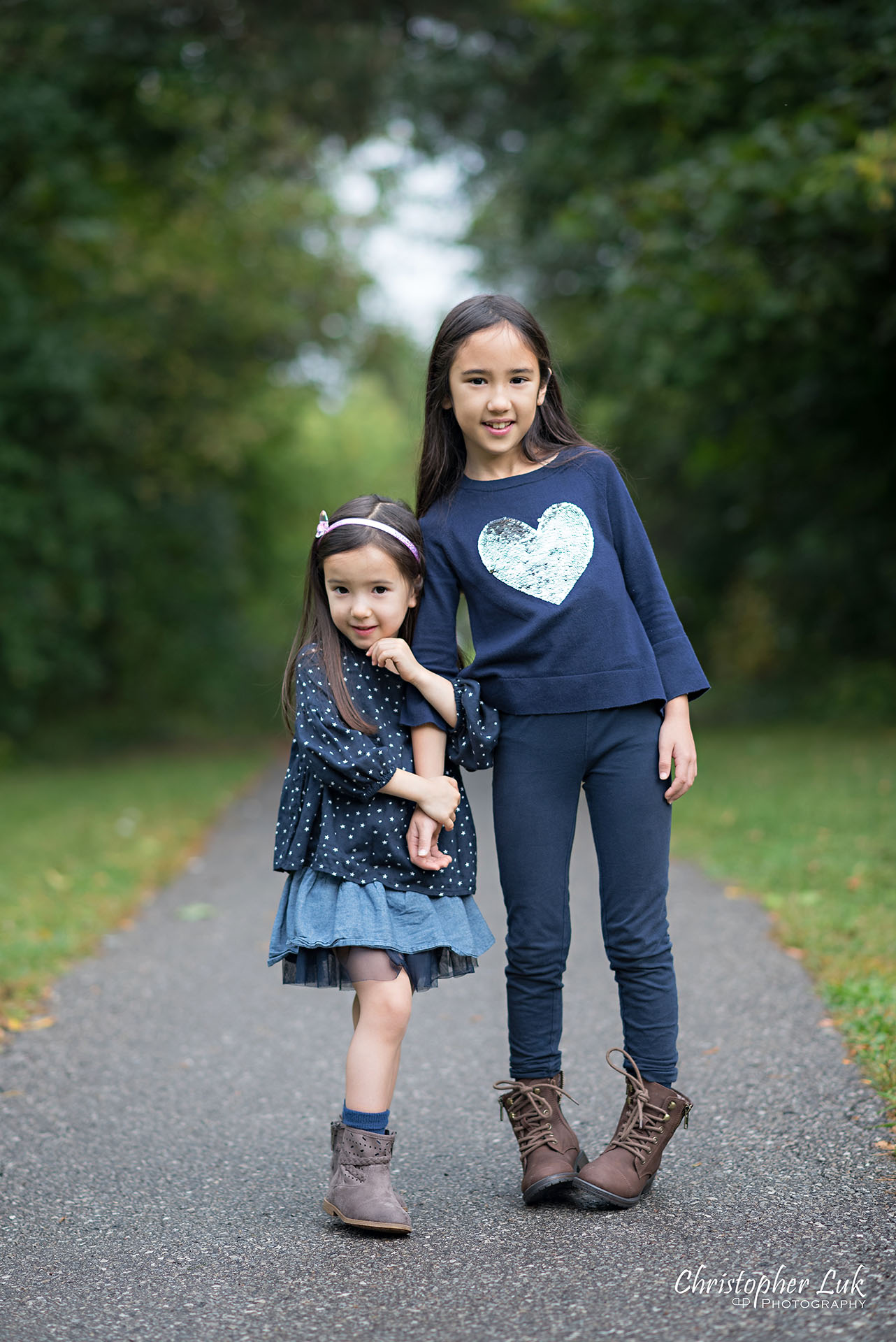 Christopher Luk Family Photographer Toronto Markham Candid Natural Photojournalistic Daughters Sisters Sisterhood Smile Hug Hugging Holding Arms Cute Adorable