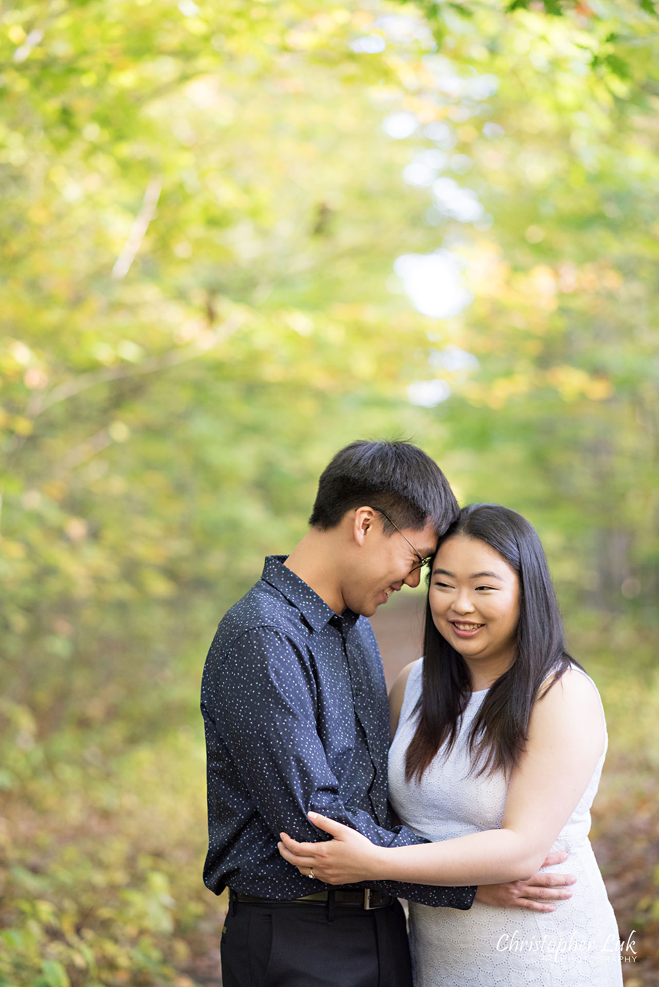 Christopher Luk Toronto Wedding Photographer Stouffville Forest Conservation Park Engagement Session Candid Natural Photojournalistic Bride Groom Hug Hold Smile Pond Autumn Fall Leaves Vertical