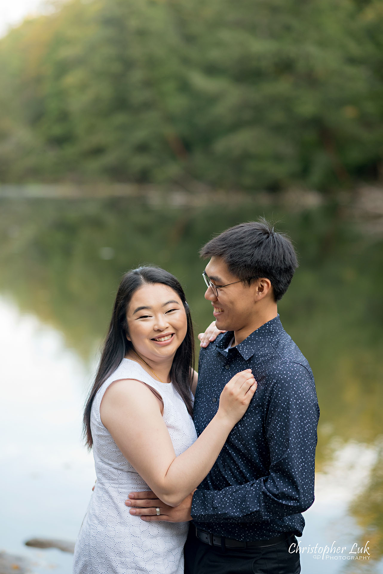 Christopher Luk Toronto Wedding Photographer Stouffville Forest Conservation Park Engagement Session Candid Natural Photojournalistic Bride Groom Walking Together Pond Lake River Scenic Water Reflection Smile Vertical
