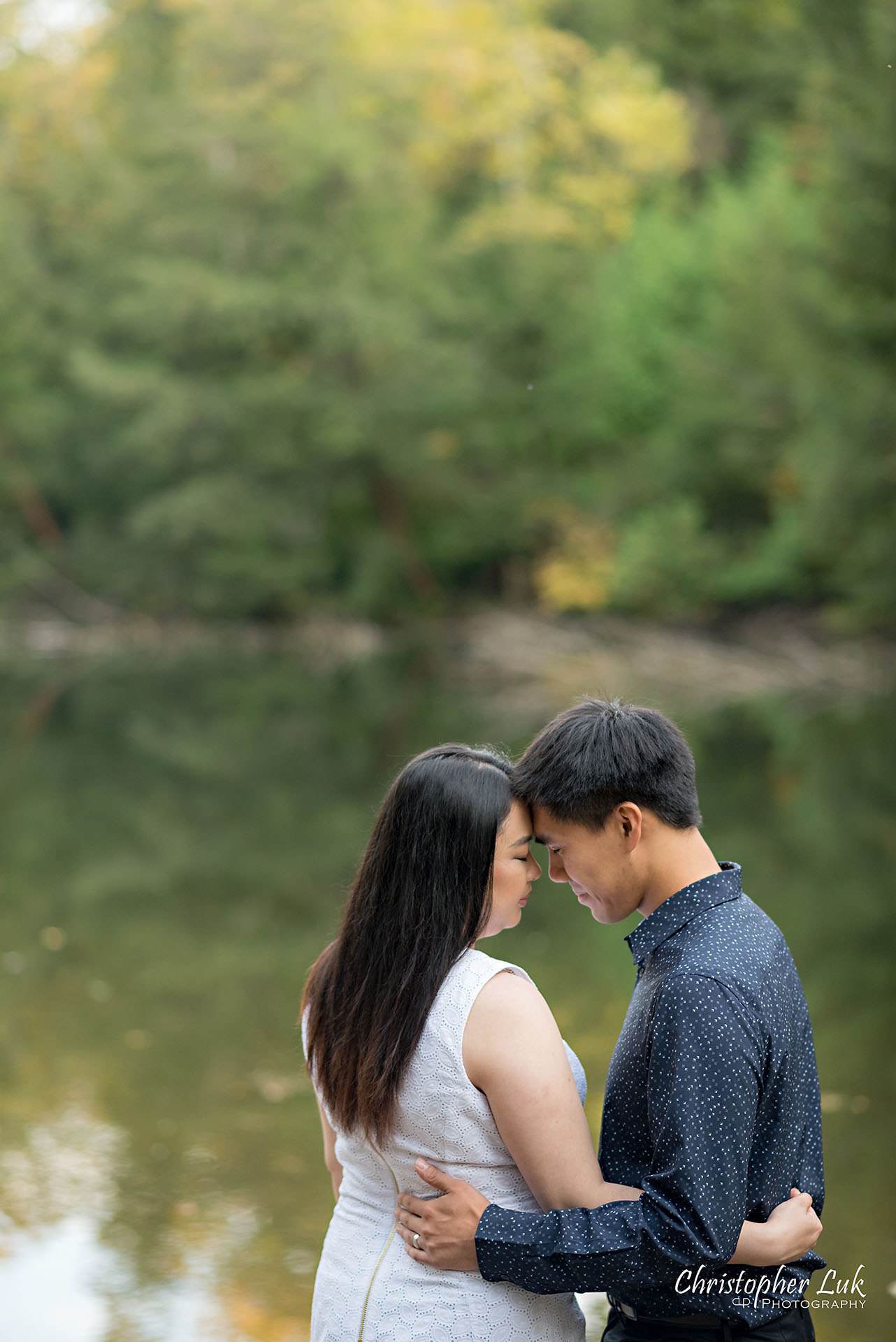 Christopher Luk Toronto Wedding Photographer Stouffville Forest Conservation Park Engagement Session Candid Natural Photojournalistic Bride Groom Walking Together Pond Lake River Scenic Water Reflection Vertical