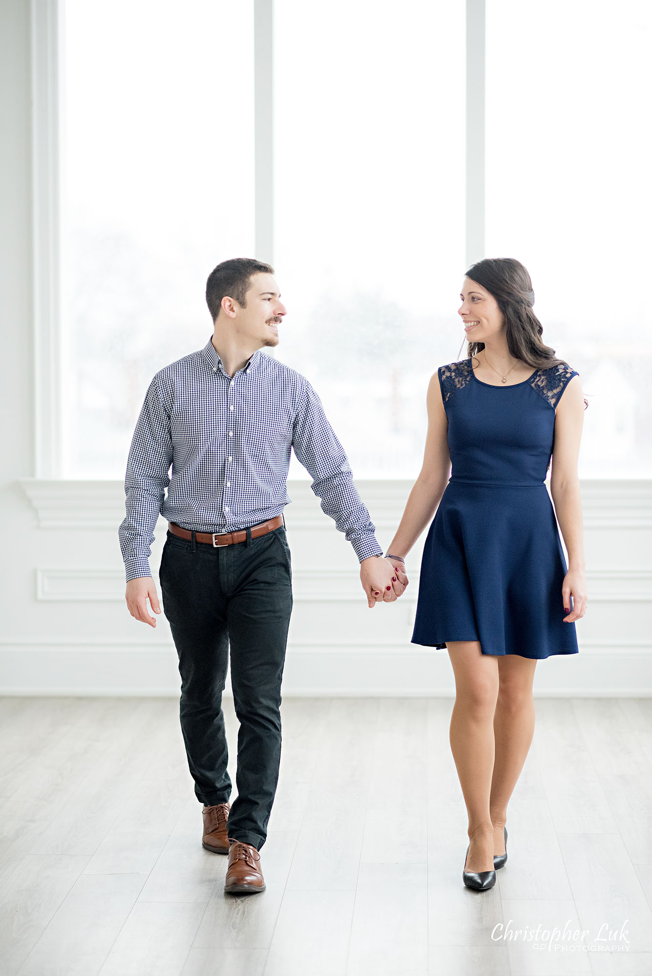 Christopher Luk Toronto Wedding Photographer Mint Room Studios Conservatory Engagement Session Winter Indoor Natural Light Candid Photojournalistic Bride Groom Holding Hands Walking Together Smile Vertical