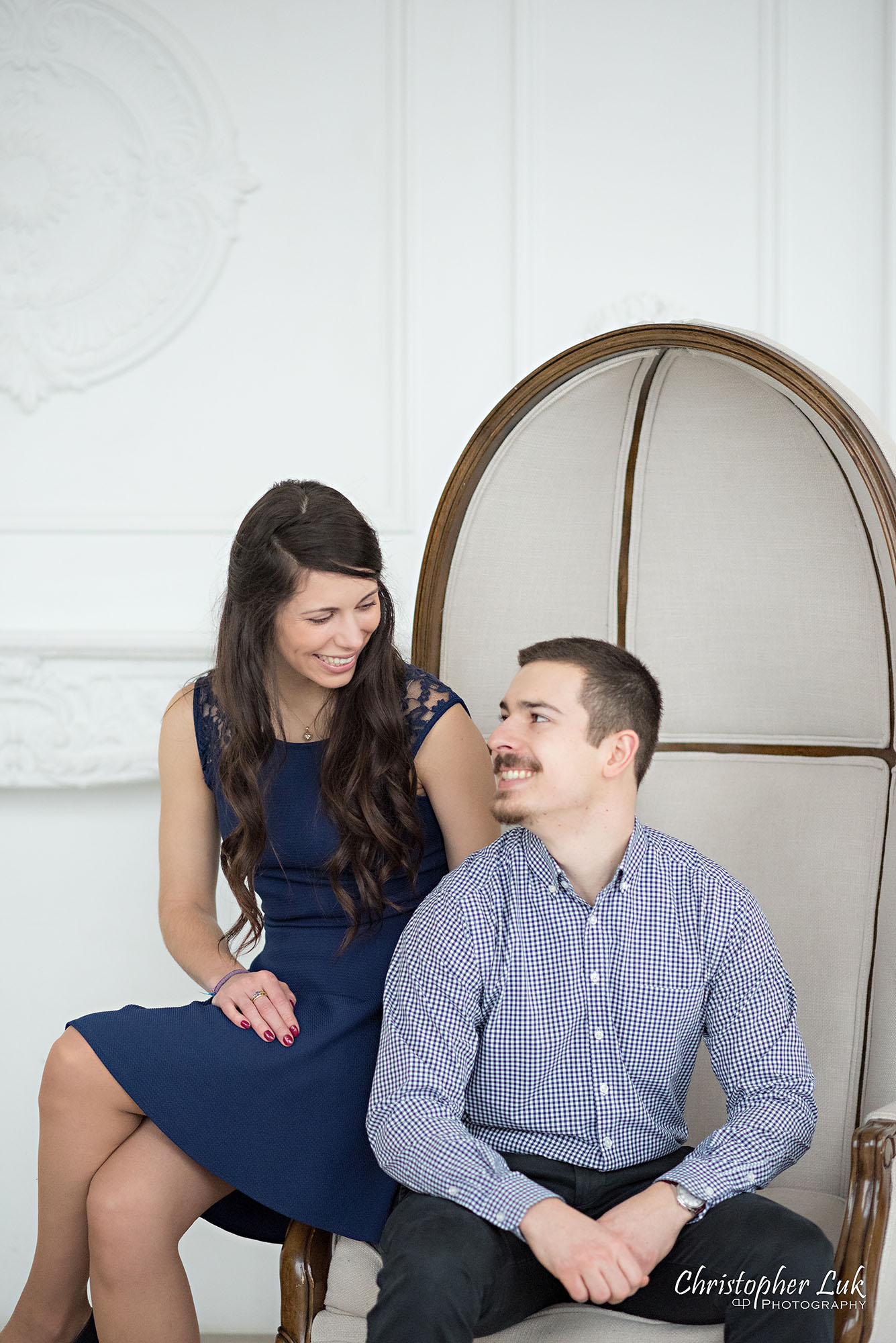 Christopher Luk Toronto Wedding Photographer Mint Room Studios Conservatory Engagement Session Winter Indoor Natural Light Candid Photojournalistic Bride Groom Beige Dome Chair Smile Portrait