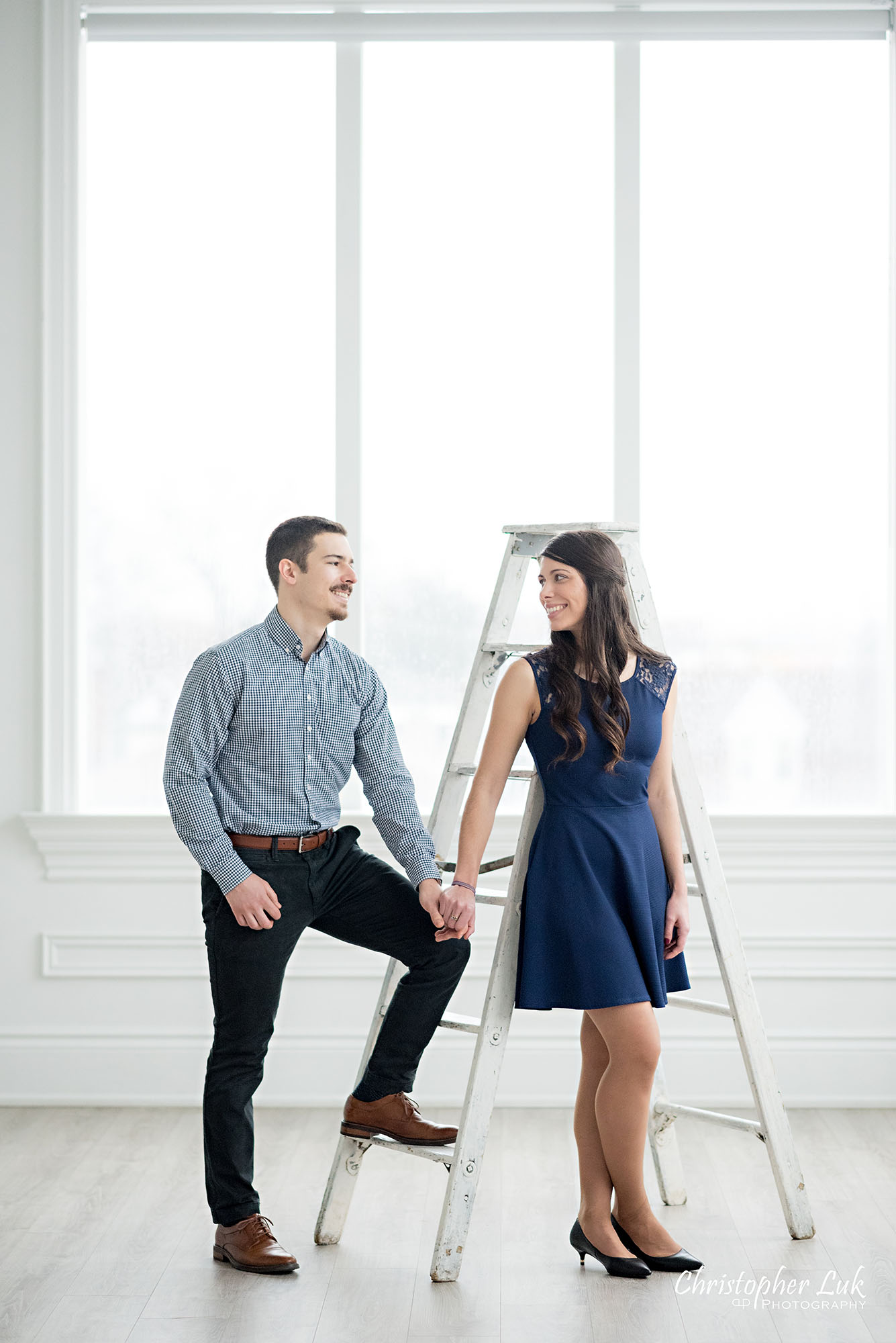 Christopher Luk Toronto Wedding Photographer Mint Room Studios Conservatory Engagement Session Winter Indoor Natural Light Candid Photojournalistic Bride Groom Vintage Rustic Ladder Window Holding Hands