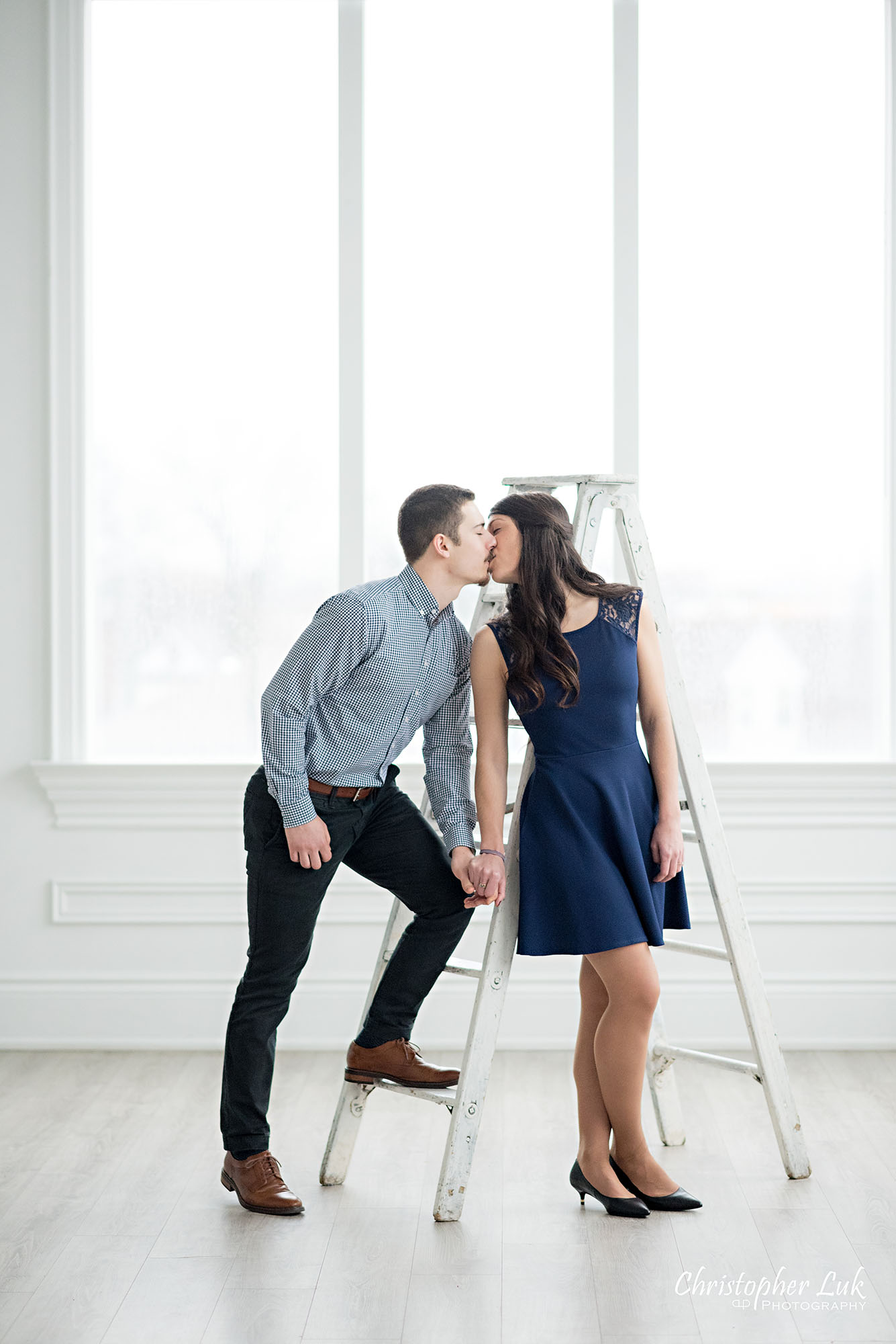 Christopher Luk Toronto Wedding Photographer Mint Room Studios Conservatory Engagement Session Winter Indoor Natural Light Candid Photojournalistic Bride Groom Vintage Rustic Ladder Window Holding Hands Kiss