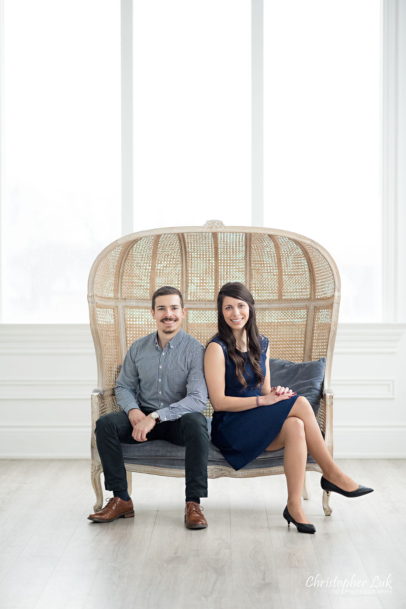 Christopher Luk Toronto Wedding Photographer Mint Room Studios Conservatory Engagement Session Winter Indoor Natural Light Candid Photojournalistic Bride Groom Wicker French Rustic Vintage Dome Loveseat Chair Smile