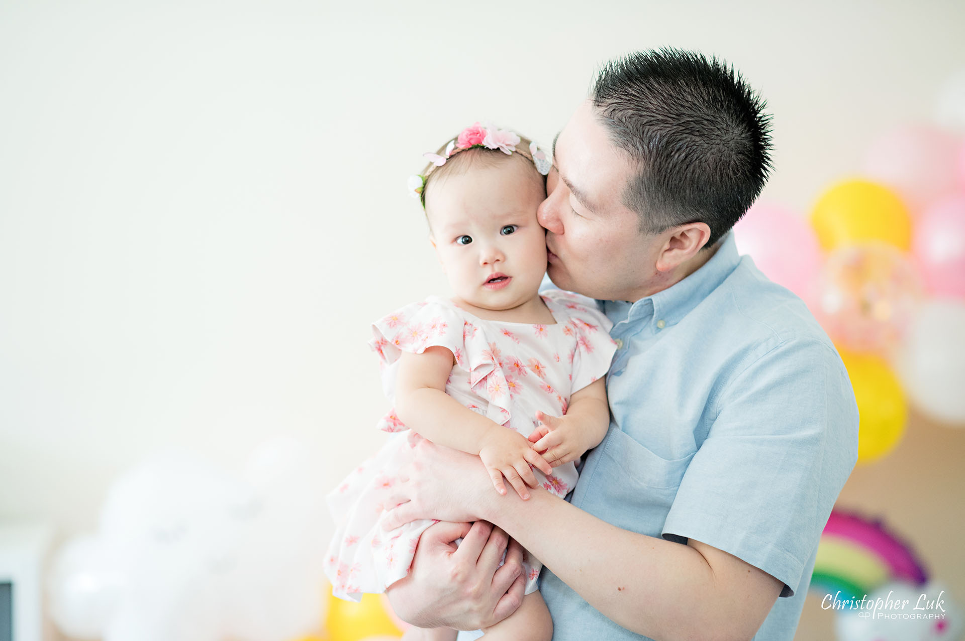 Christopher Luk Toronto Markham Family Photographer Baby Girl First Birthday Balloon Arch Rainbow Pink Sun Clouds Decor Father Dad Daughter Fatherhood Hug Kiss Natural Candid Photojournalistic