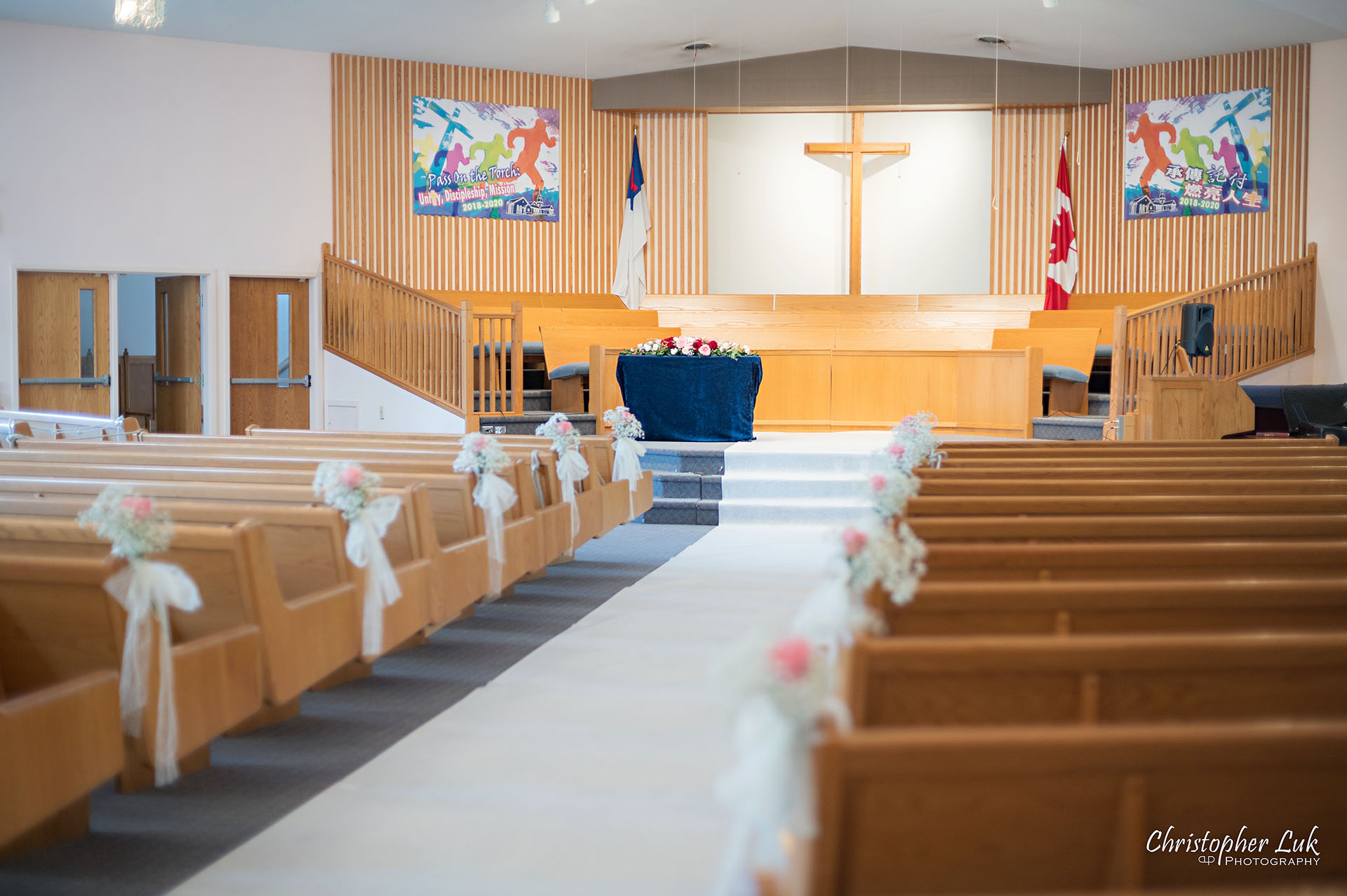 Christopher Luk Toronto Wedding Photographer Bridle Trail Baptist Church Unionville Main Street Crystal Fountain Event Venue Ceremony Location Interior Pews Rows Flowers Little White Baby's Breath Rose Pink Drapery Fabric Flower Bell by Masami Decor Cross Sanctuary Altar Detail