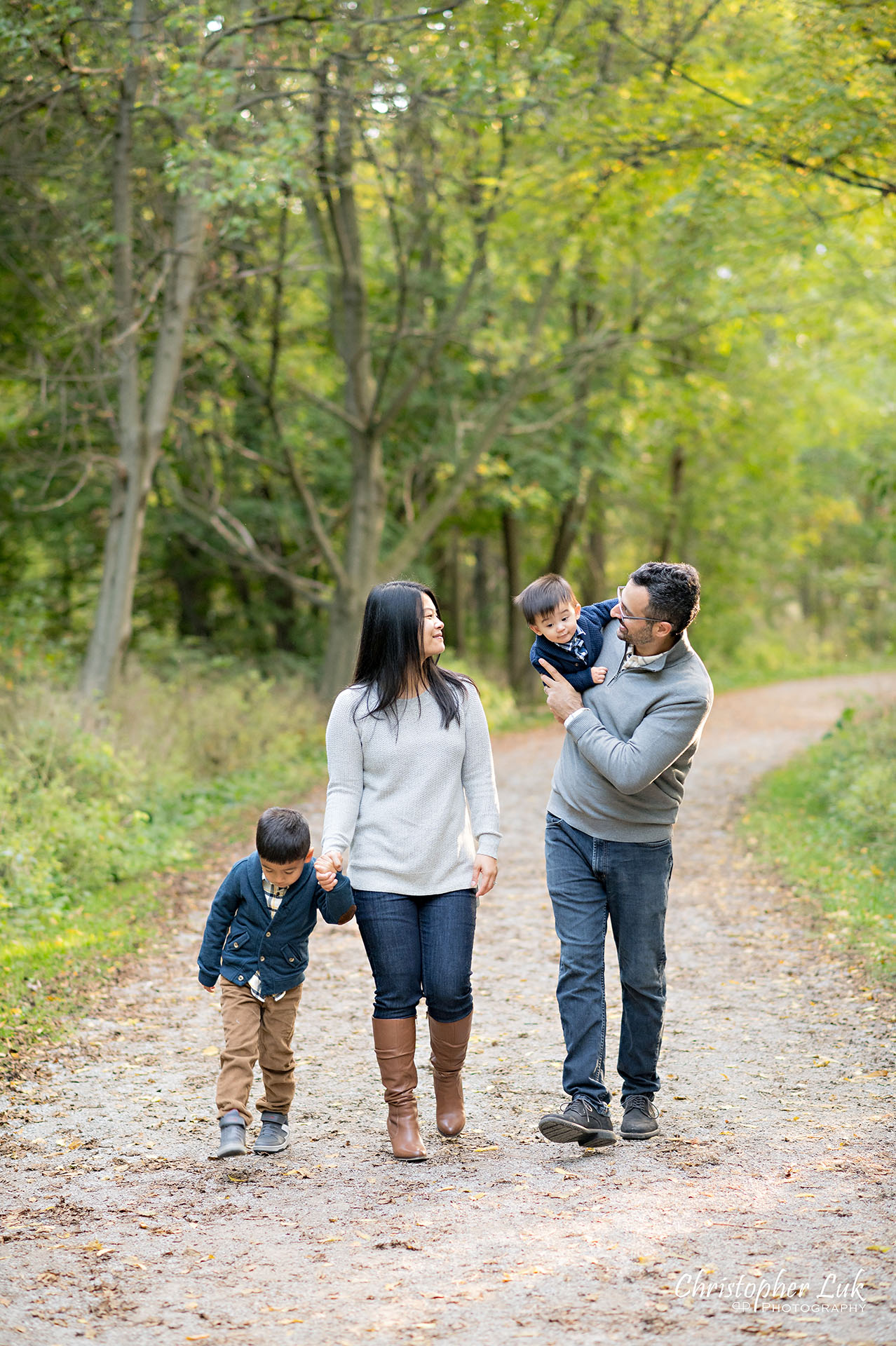 Christopher Luk Family Photographer Toronto Markham Unionville Autumn Fall Leaves Natural Candid Photojournalistic Sons Brothers Baby Boys Father Dad Mother Mom Motherhood Fatherhood Holding Hands Walking Together Trail Pathway Forest Fun Happy