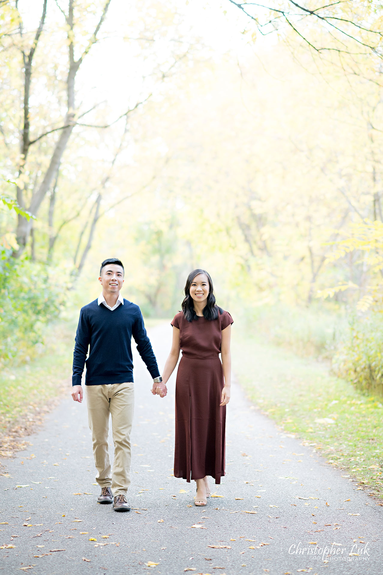 Christopher Luk Toronto Wedding Engagement Session Photographer Autumn Fall Leaves Natural Candid Photojournalistic Bride Groom Holding Hands Walking Together Pathway Hiking Trail