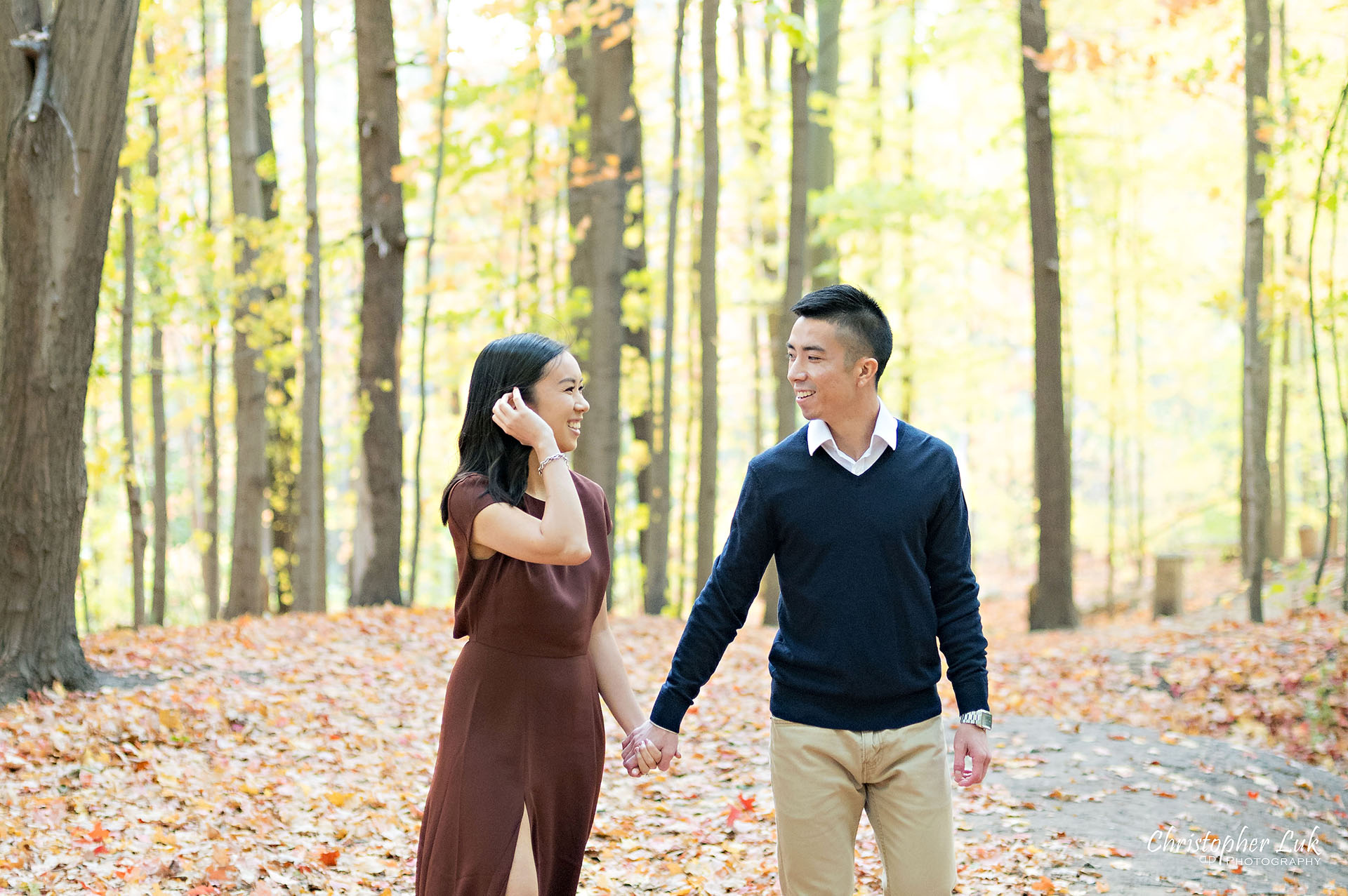 Christopher Luk Toronto Wedding Engagement Session Photographer Autumn Fall Leaves Natural Candid Photojournalistic Bride Groom Hiking Trail Trees Smiling Each Other Happy Walking Holding Hands Together Landscape Small