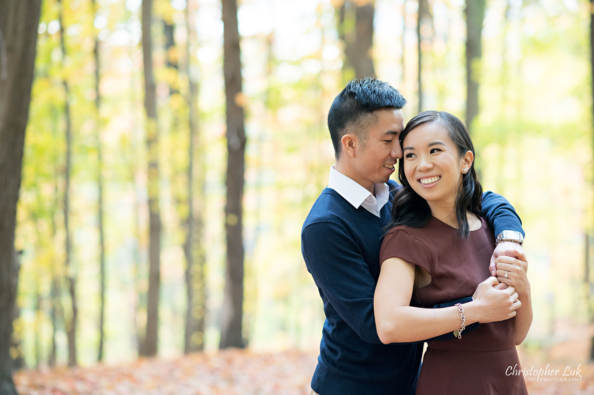Christopher Luk Toronto Wedding Engagement Session Photographer Autumn Fall Leaves Natural Candid Photojournalistic Bride Groom Hiking Trail Trees Smiling Hug Hugging Each Other Happy Together