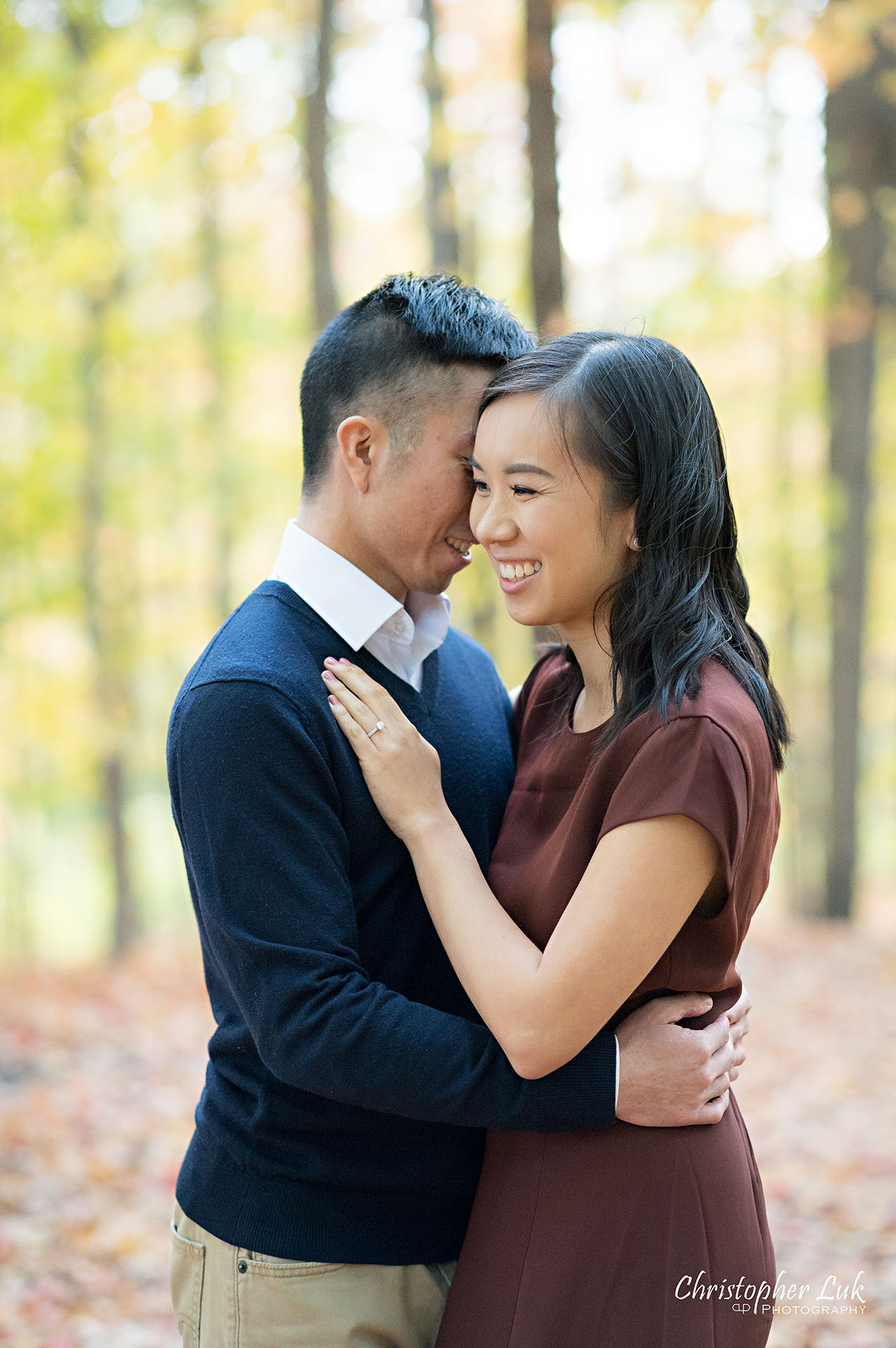 Christopher Luk Toronto Wedding Engagement Session Photographer Autumn Fall Leaves Natural Candid Photojournalistic Bride Groom Hiking Trail Trees Smiling Hug Hugging Each Other Happy Together