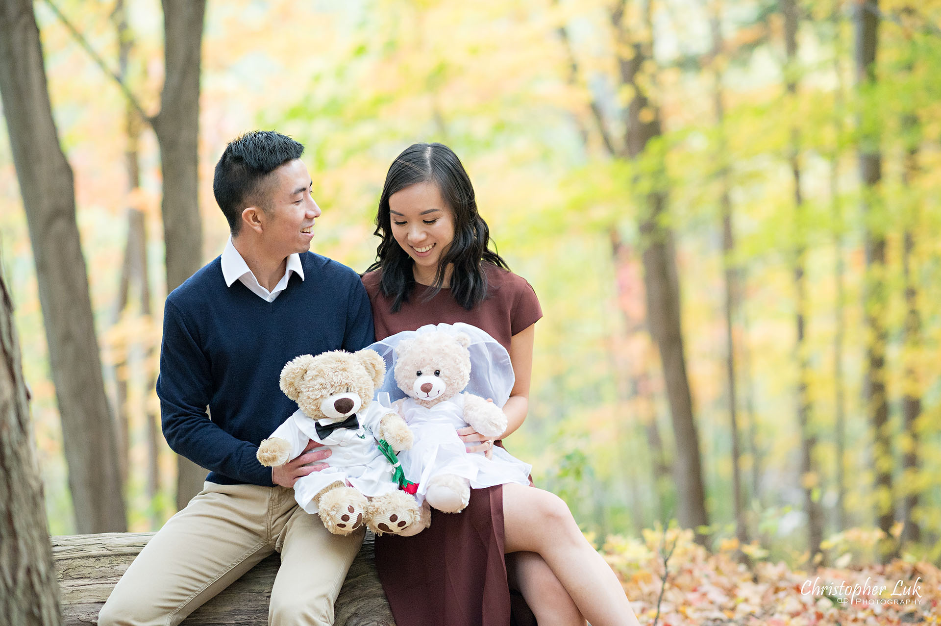 Christopher Luk Toronto Wedding Engagement Session Photographer Autumn Fall Leaves Natural Candid Photojournalistic Bride Groom Hiking Trail Stuffed Animal WongFu Productions Spencer Bear Trees Log Smiling Happy Together Landscape