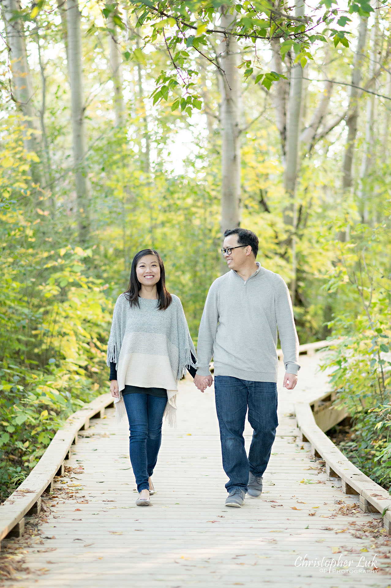 Christopher Luk Markham Family Photographer Autumn Leaves Fall Season Candid Photojournalistic Natural Bright Timeless Elegant Boardwalk Mother Father Husband Wife Holding Hands Walking Together