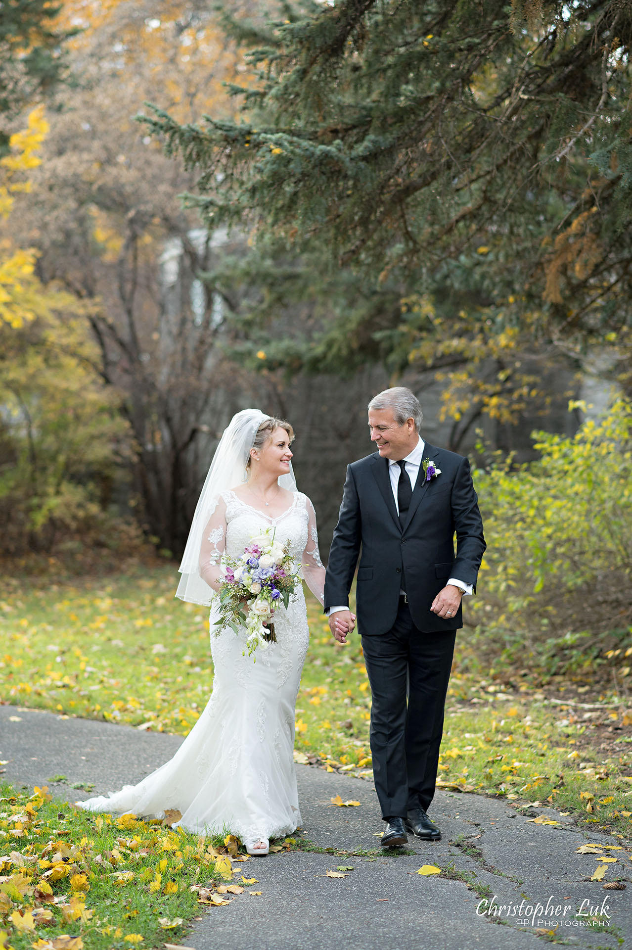 Christopher Luk Toronto Wedding Photographer Natural Candid Photojournalistic Tyndale Chapel Autumn Fall Leaves Bride Groom Holding Hands Walking Together Portrait