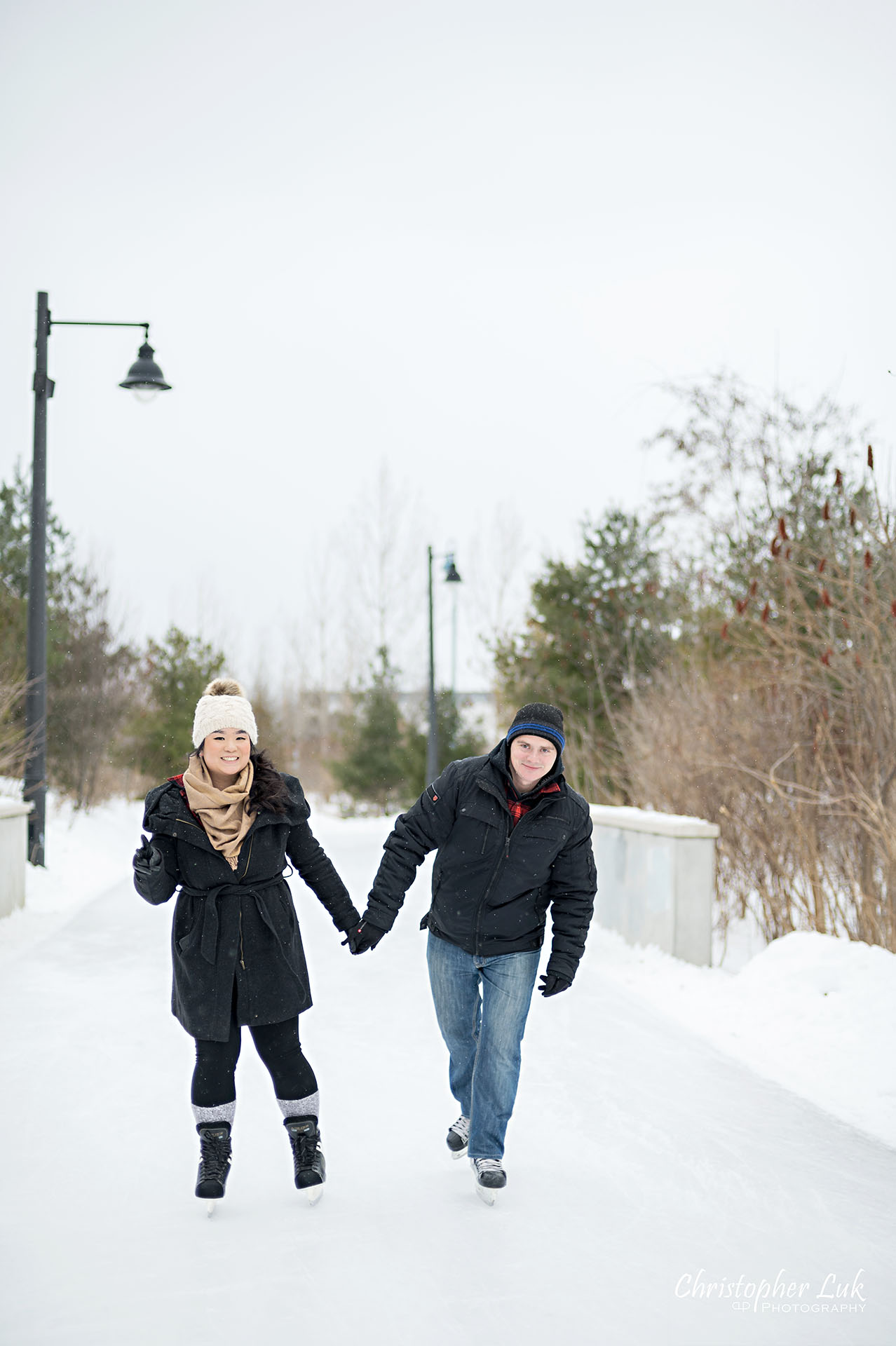 Christopher Luk Toronto Wedding Photographer Ice Skating Trail Winter Engagement Session Natural Photojournalistic Candid Bride Groom Holding Hands Bridge Funny Fun Peace Fingers Hand Sign