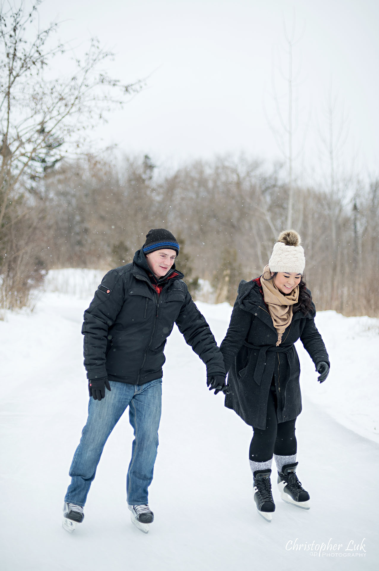 Christopher Luk Toronto Wedding Photographer Ice Skating Trail Winter Engagement Session Natural Photojournalistic Candid Bride Groom Holding Hands Bridge Close