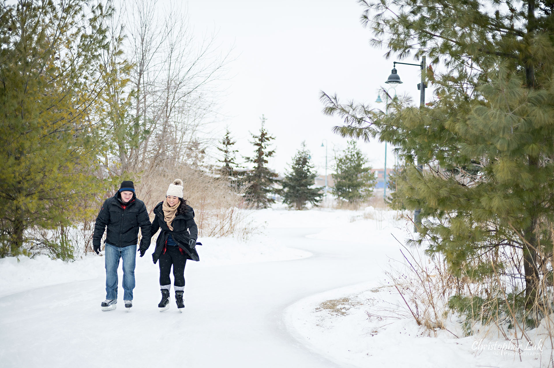 Christopher Luk Toronto Wedding Photographer Ice Skating Trail Winter Engagement Session Natural Photojournalistic Candid Bride Groom Landscape Holding Hands Landscape Curve Smile