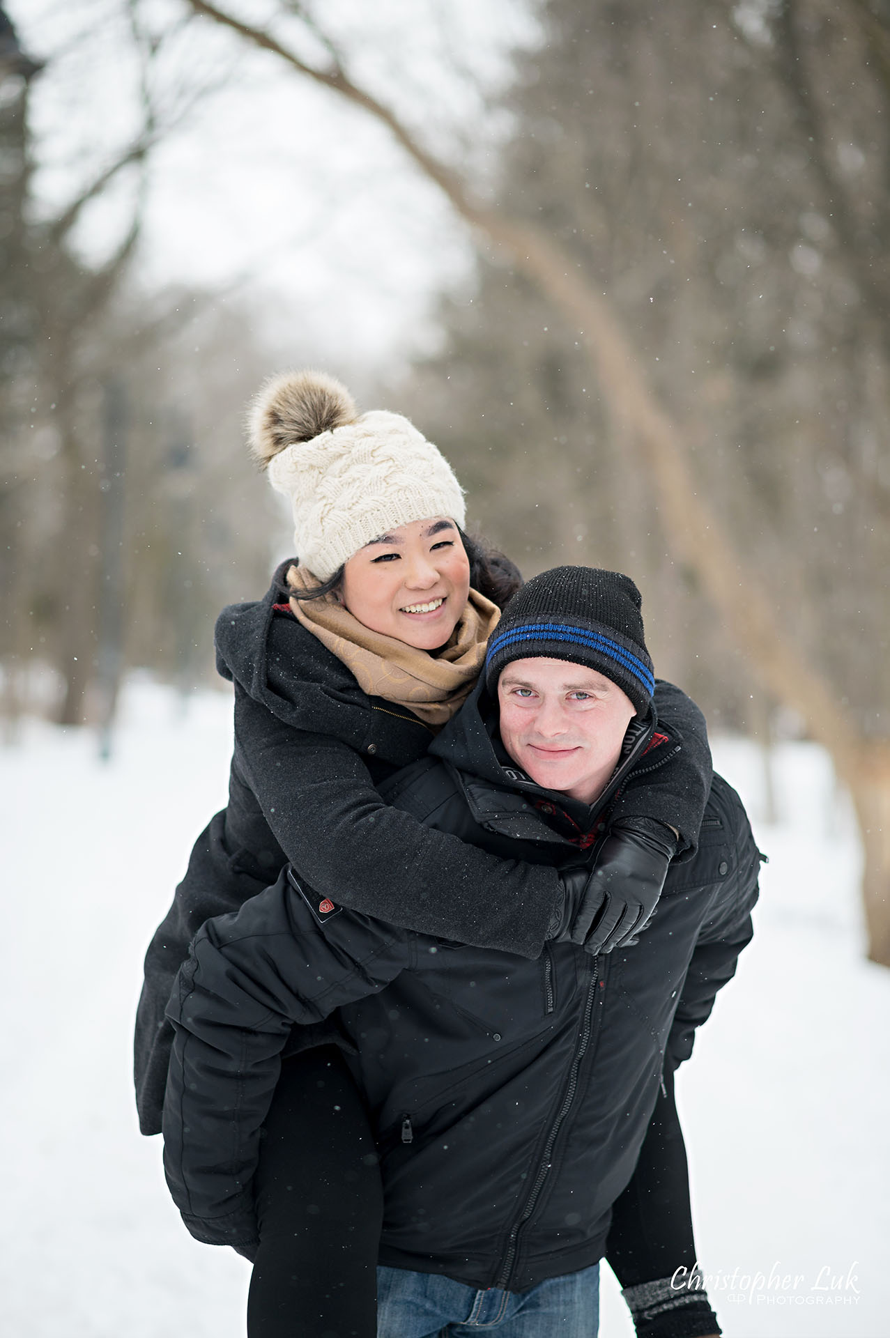Christopher Luk Toronto Wedding Photographer Ice Skating Trail Winter Engagement Session Natural Photojournalistic Candid Bride Groom Portrait Colonel Samuel Smith Park Double Tree Lined Walking Path Pathway Walkway Landscape Piggyback Carrying Cute Fun Smile