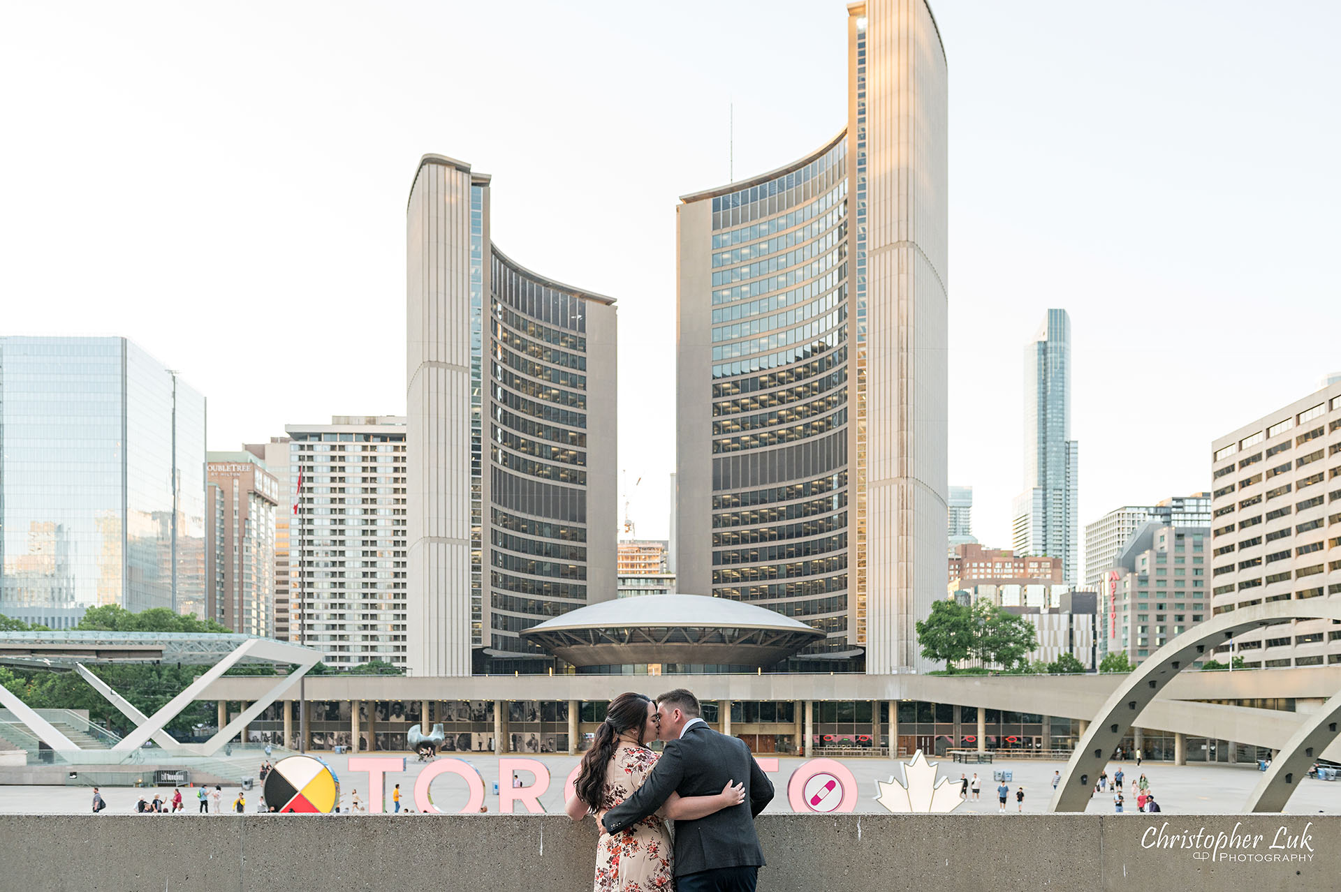 Christopher Luk Toronto Wedding Photographer Engagement Photos Pictures Session Osgoode Hall Nathan Philips Square City Hall Waterfall 3D Sign Bride Groom Kiss Sunset Landscape