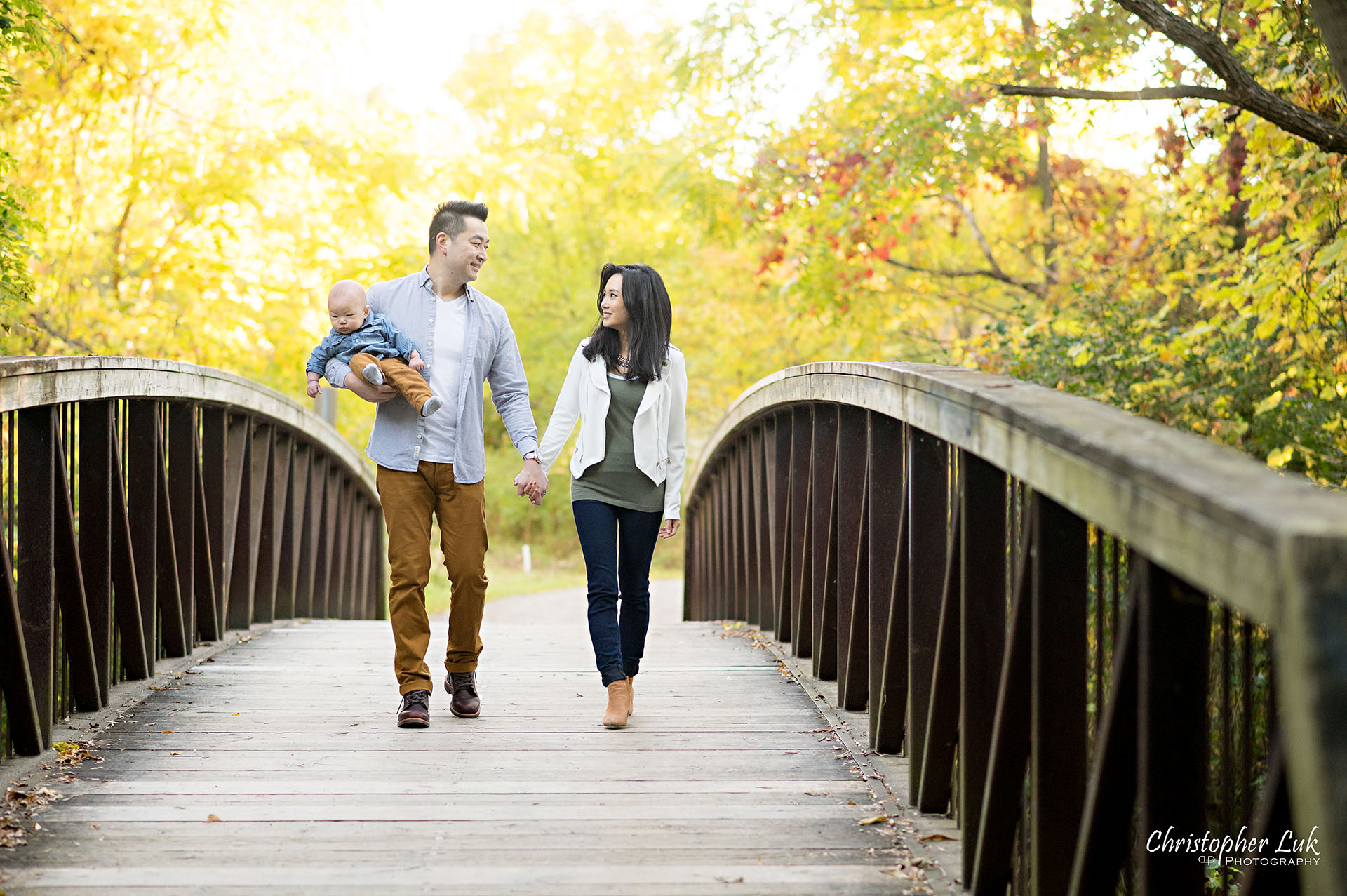 Mother Father Son Baby Walking Together on Bridge Autumn Fall Leaves Markham Unionville Toronto Family Photographer