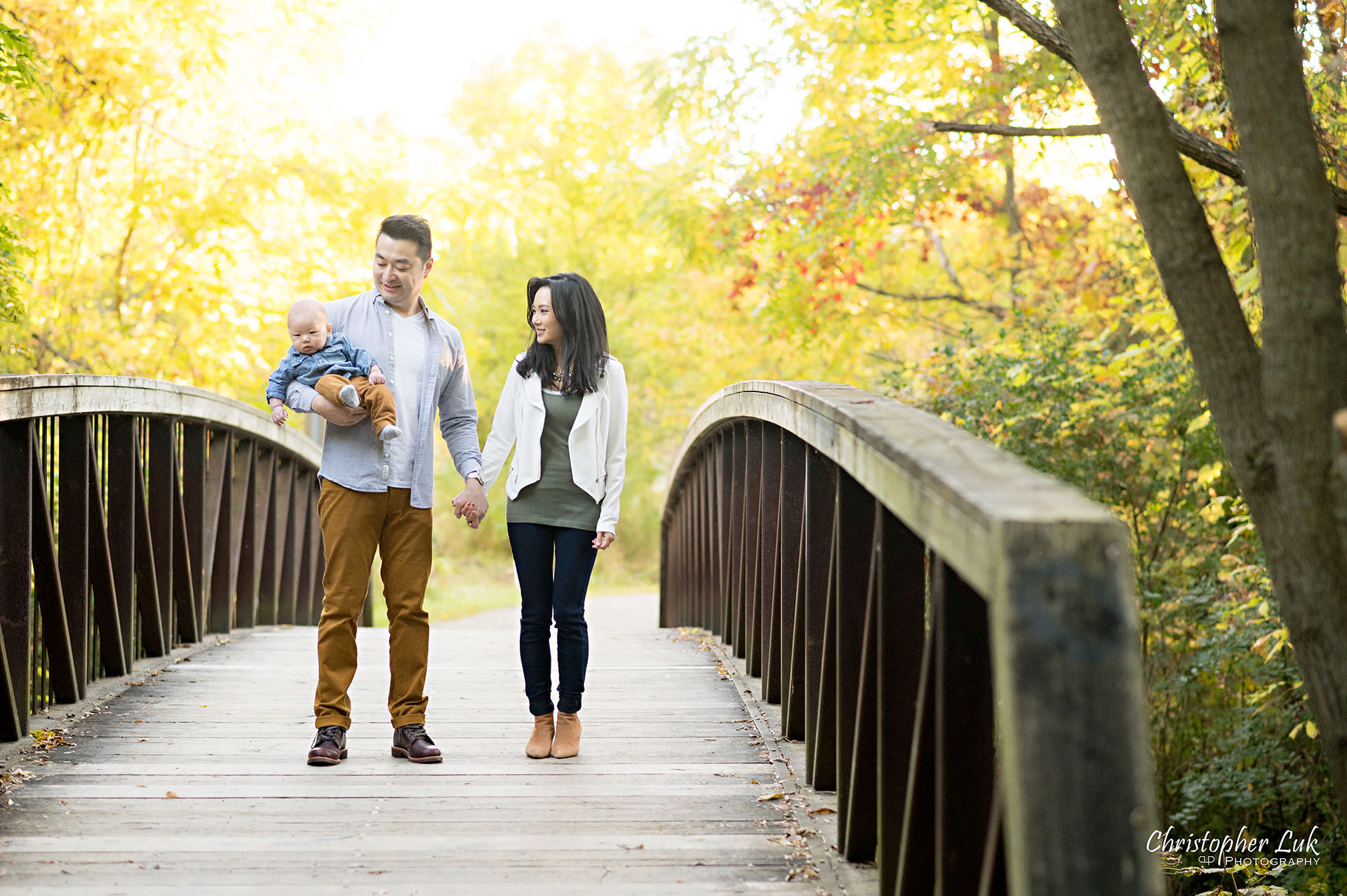 Mother Father Son Baby Walking Together on Bridge Autumn Fall Leaves Markham Unionville Toronto Family Photographer